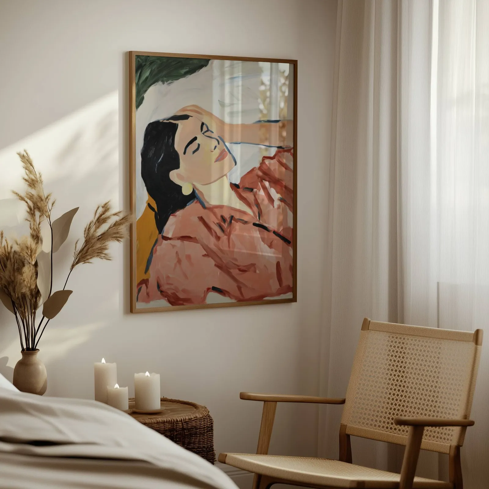 terracotta abstract woman wall art, above a woven side table with lit candles and pampas grass