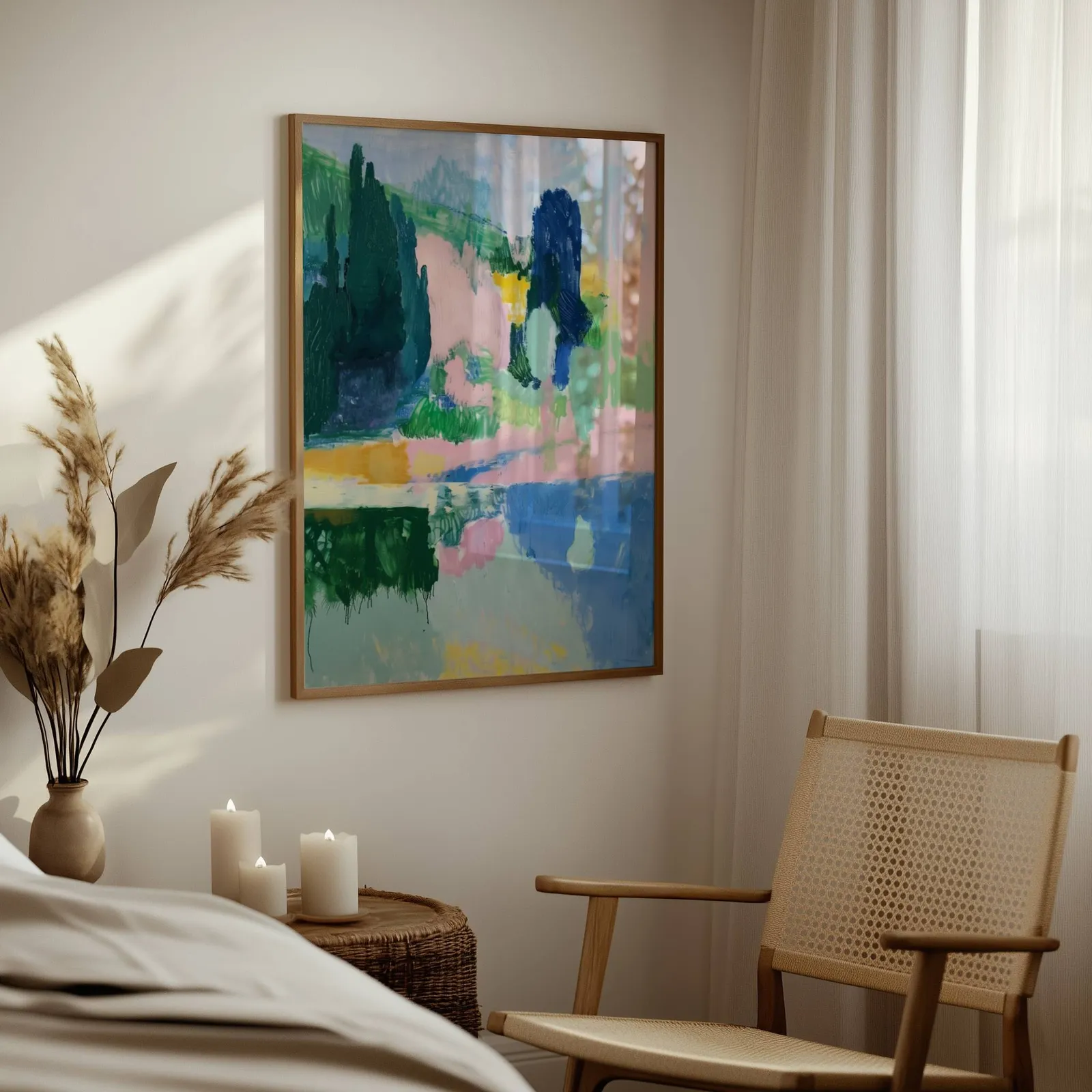 pink and green abstract landscape wall art, above a woven side table with lit candles and pampas grass