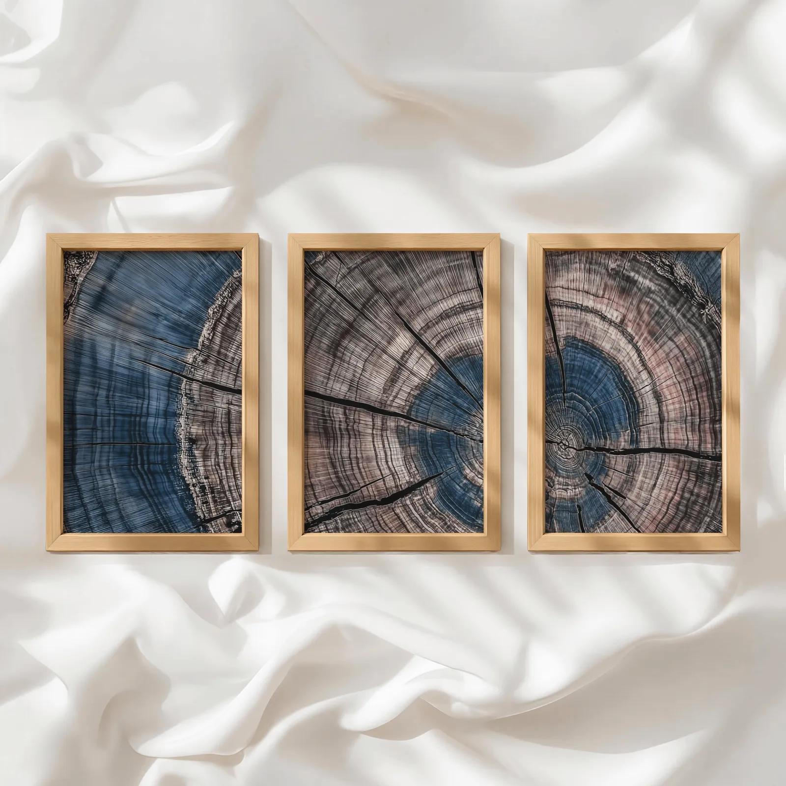 blue and pink tree rings triptych wall art, in a row atop rumpled white silky fabric