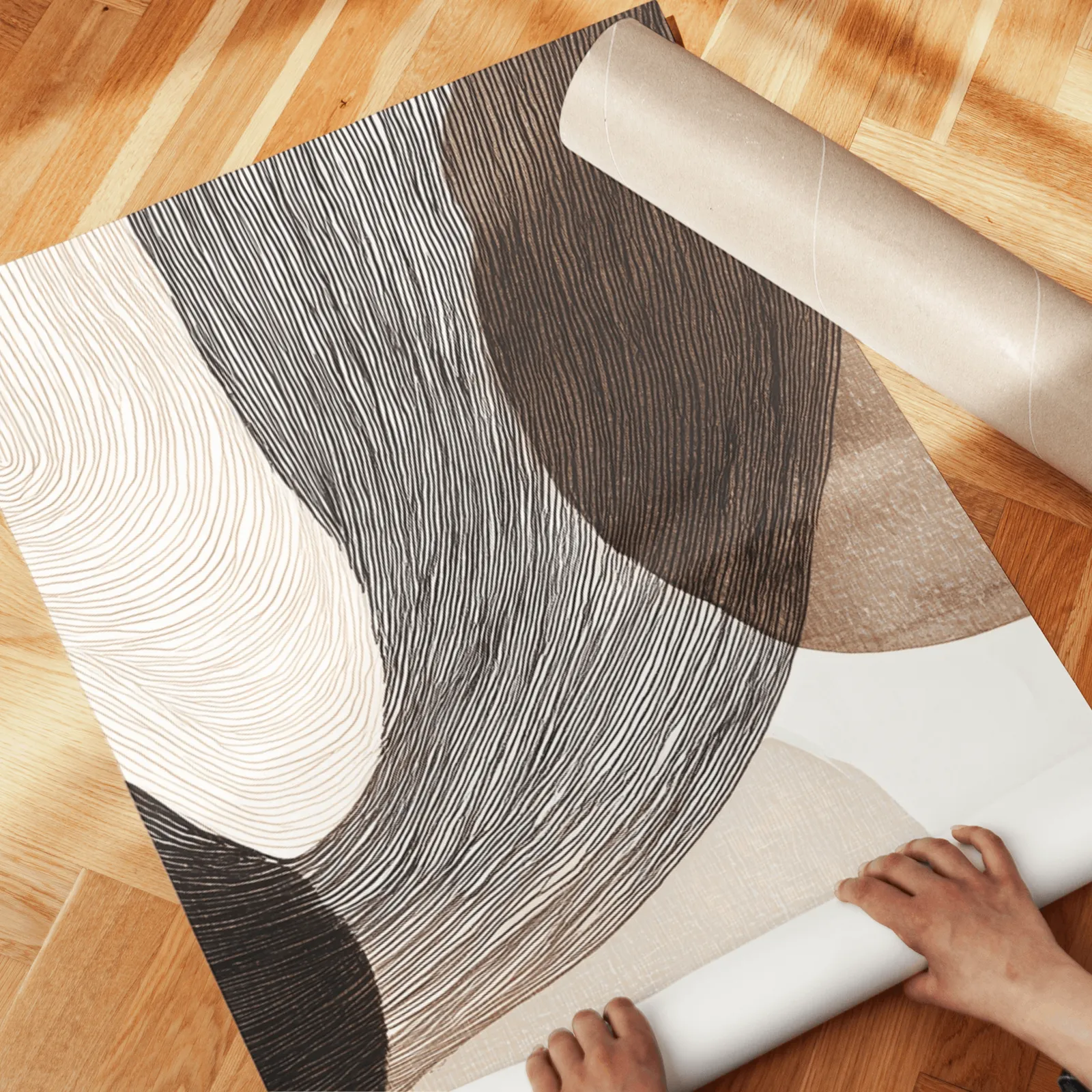 neutral abstract wall art set of 3 with curved organic forms, unrolled across a herringbone wood floor by hand