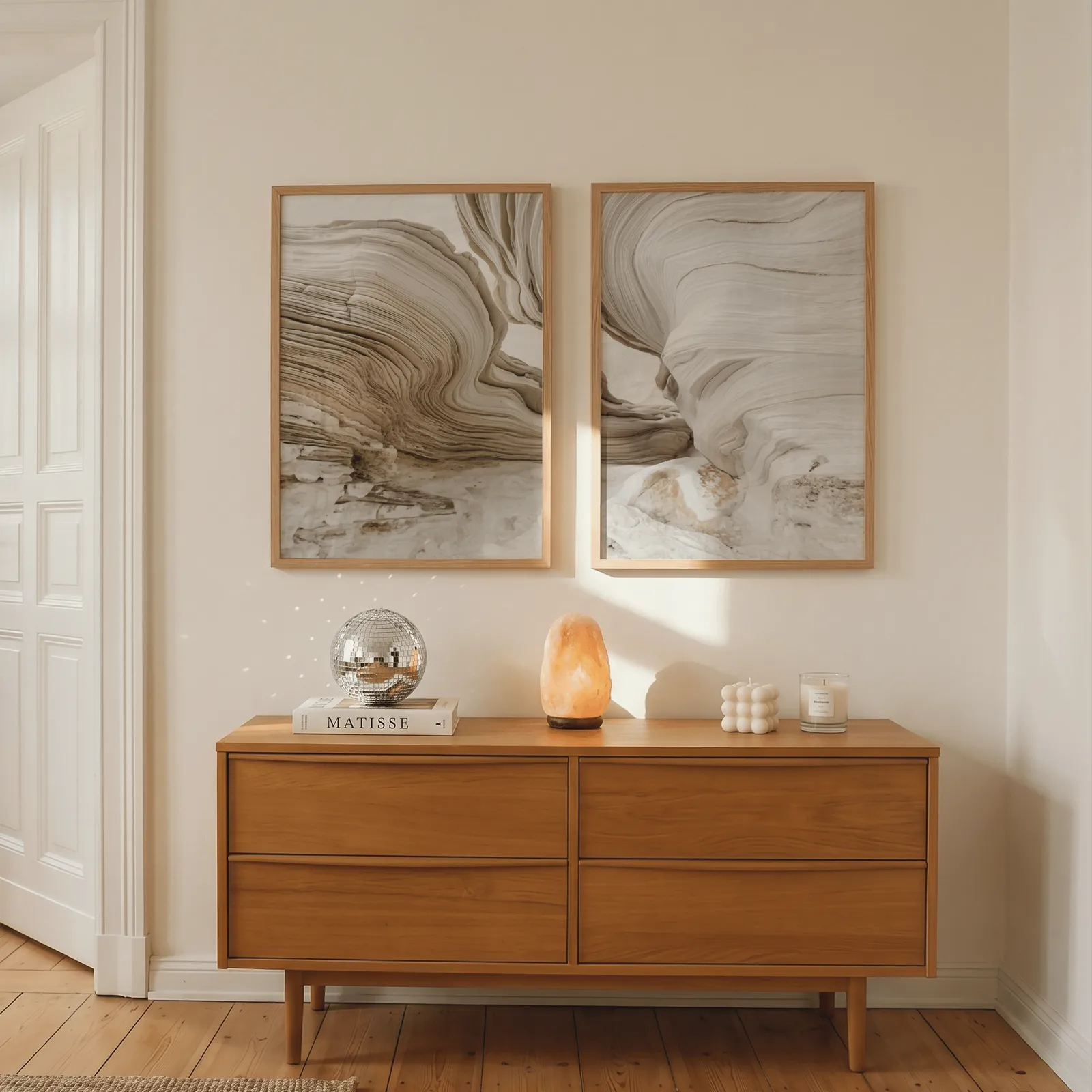 beige abstract stone texture wall art set of 2, above a wooden dresser with a salt lamp and disco ball