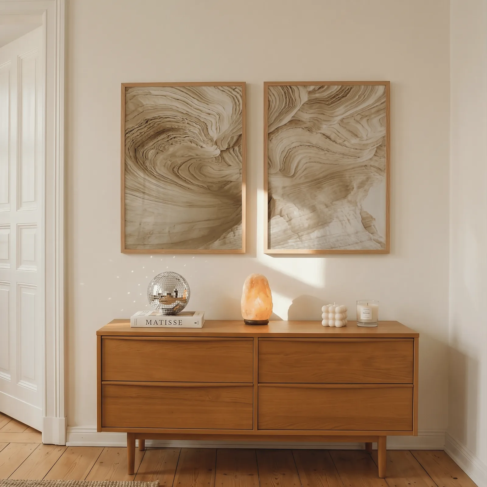 beige abstract nature wall art set of 2, above a wooden dresser with a salt lamp and disco ball