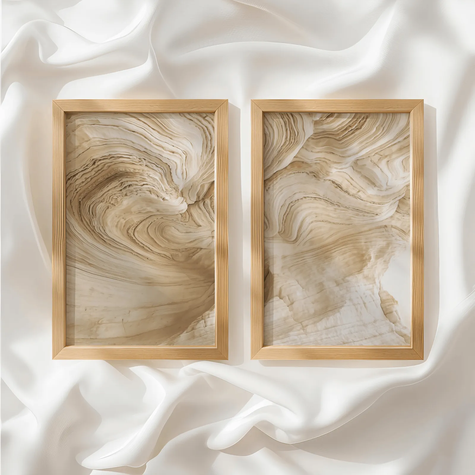 beige abstract nature wall art set of 2, side by side atop rumpled white silky fabric