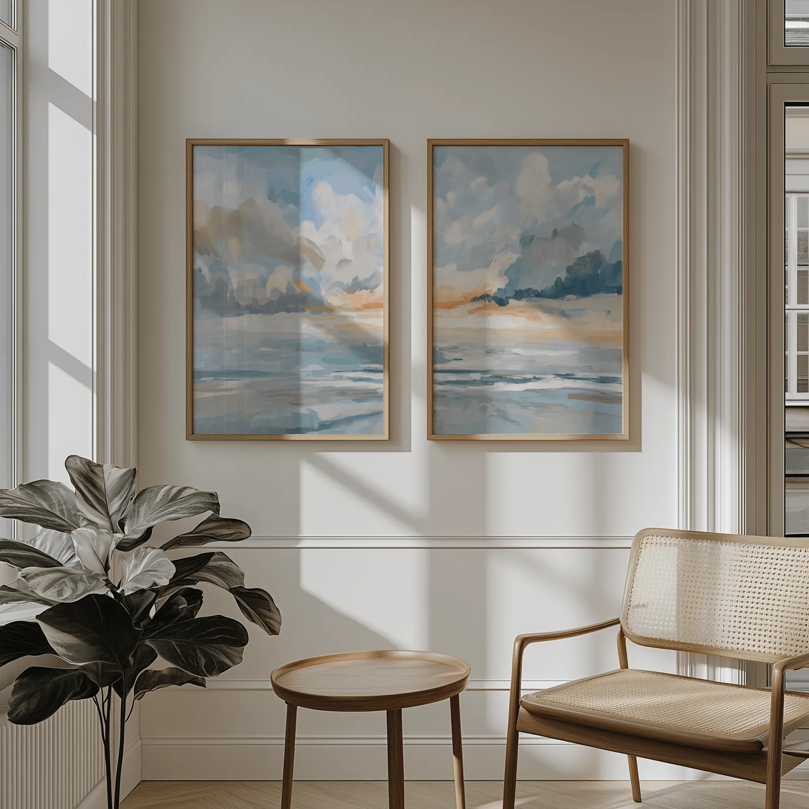 blue and orange coastal sky wall art set of two, above wainscoting beside a cane armchair and fiddle-leaf fig