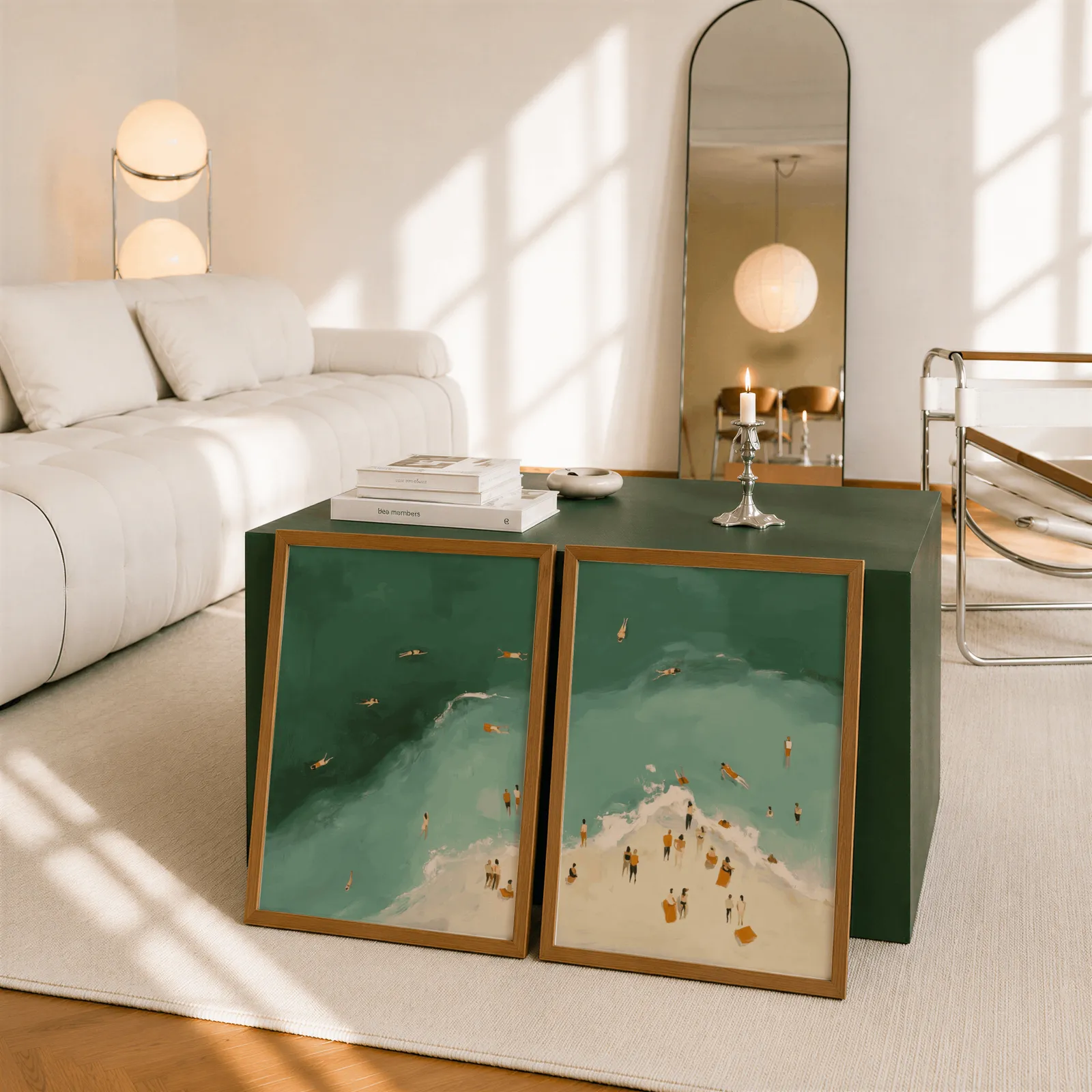 green coastal beach wall art set of two with swimmers, leaning against a dark green cube table beside an arched mirror