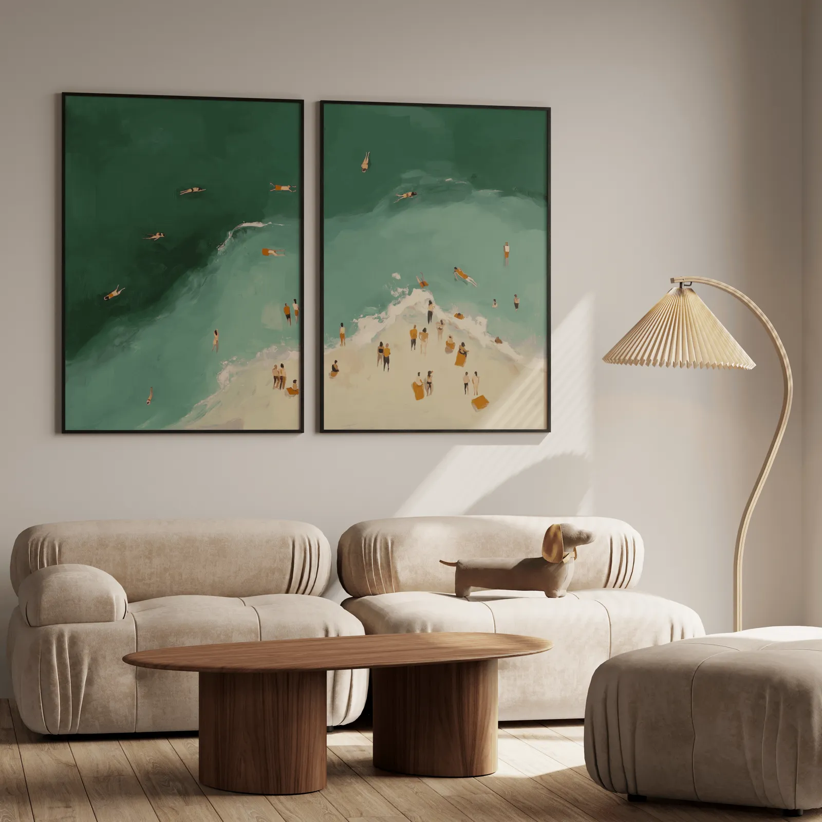 green coastal beach wall art set of two with swimmers, above a plush beige sofa with a pleated lamp nearby