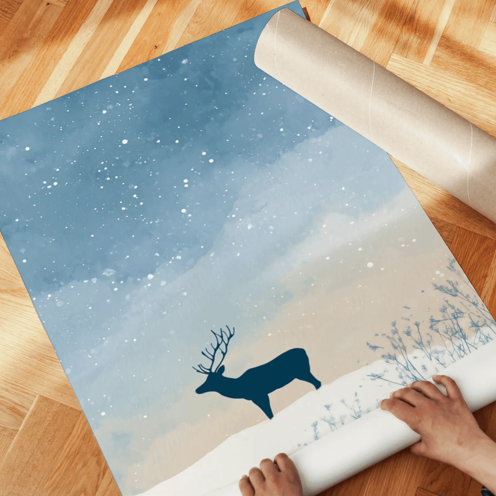 blue winter landscape wall art set with deer silhouette, unrolled across a herringbone parquet floor by hand