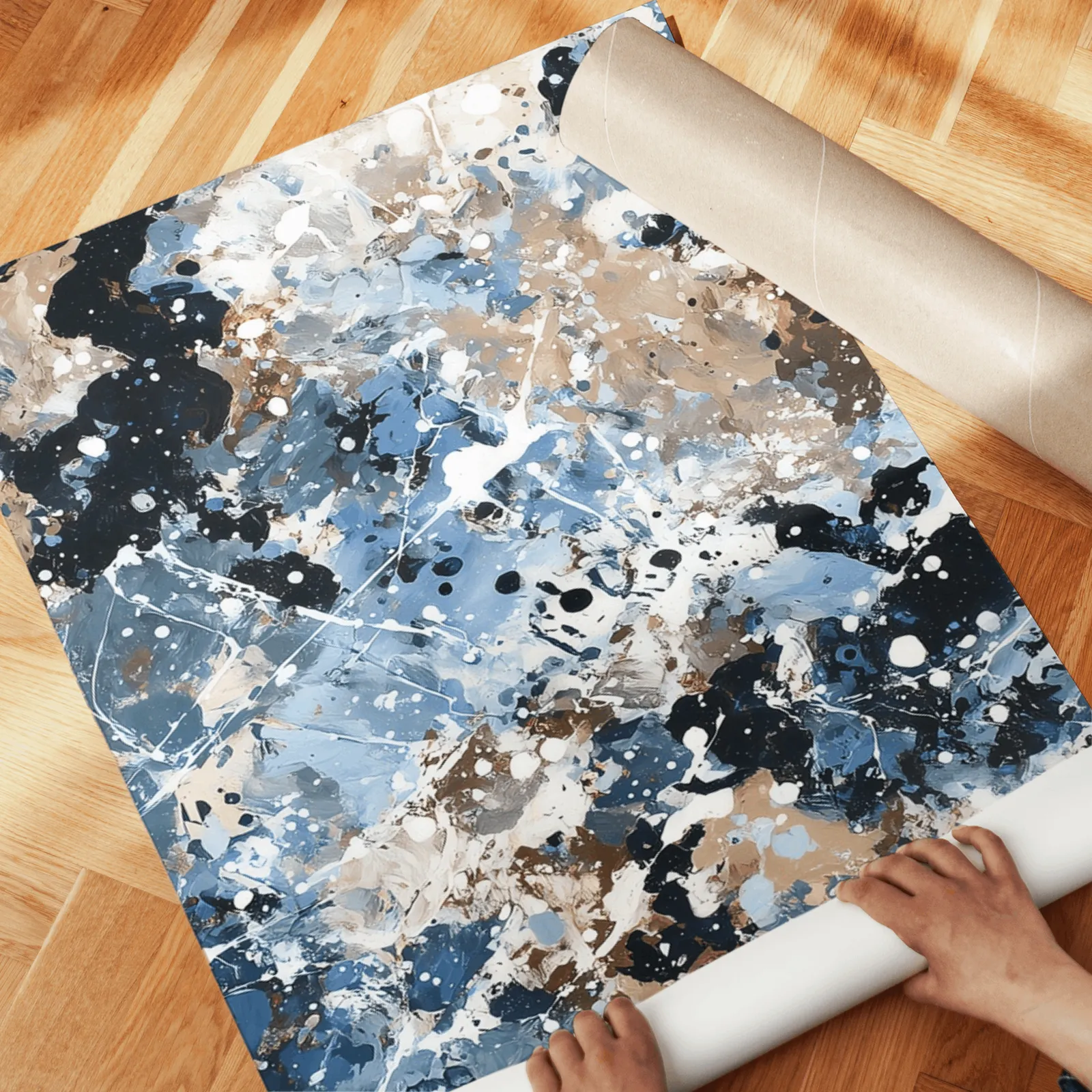 blue brown abstract splatter triptych wall art, unrolled across a herringbone wood floor by hand