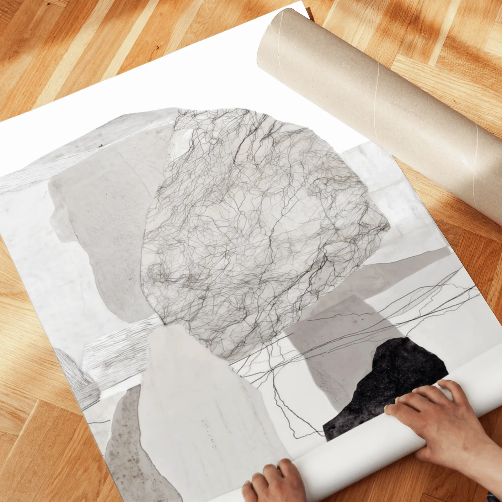 neutral abstract stone wall art set of two, unrolled across a herringbone parquet floor by hand