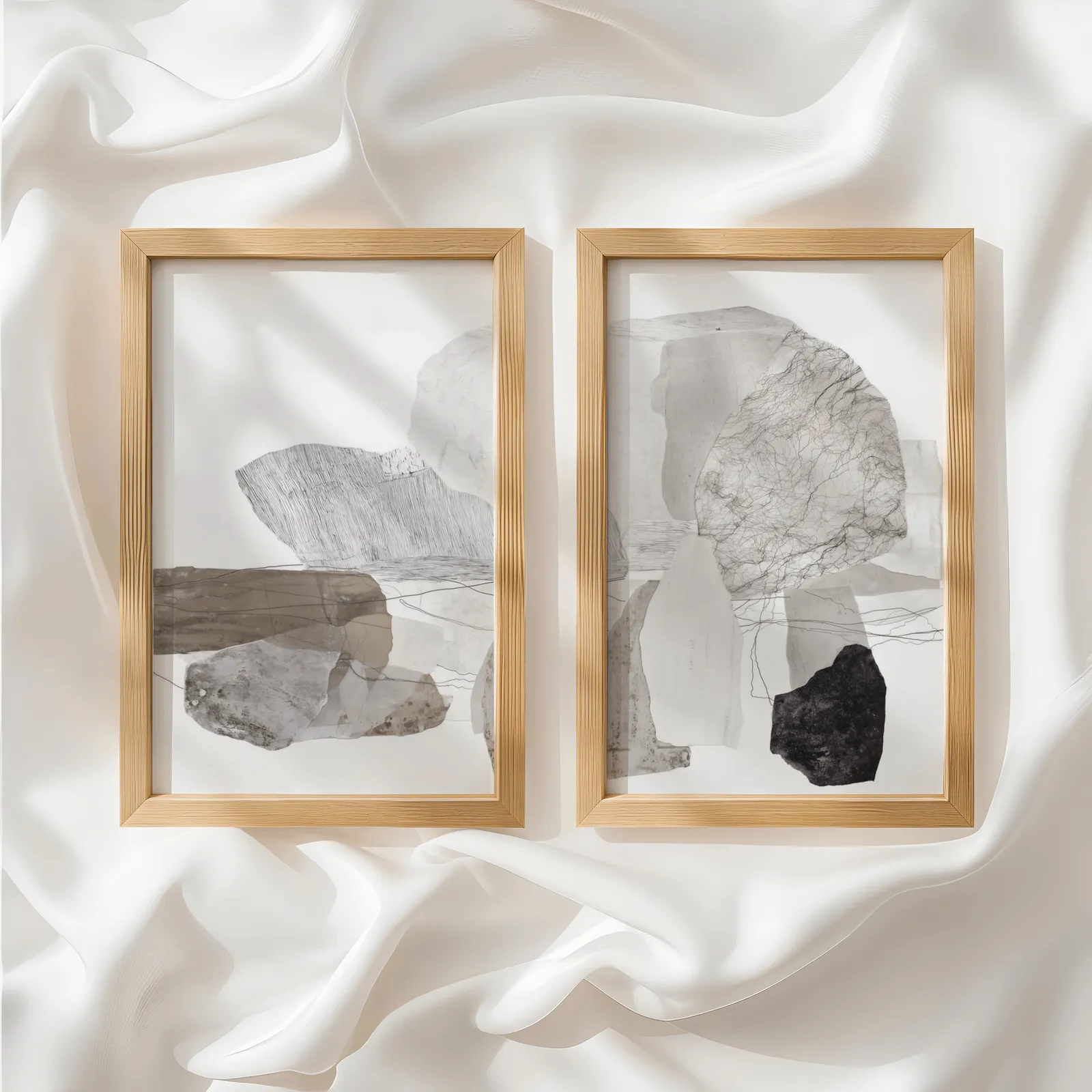 neutral abstract stone wall art set of two, side by side atop rumpled white silky fabric