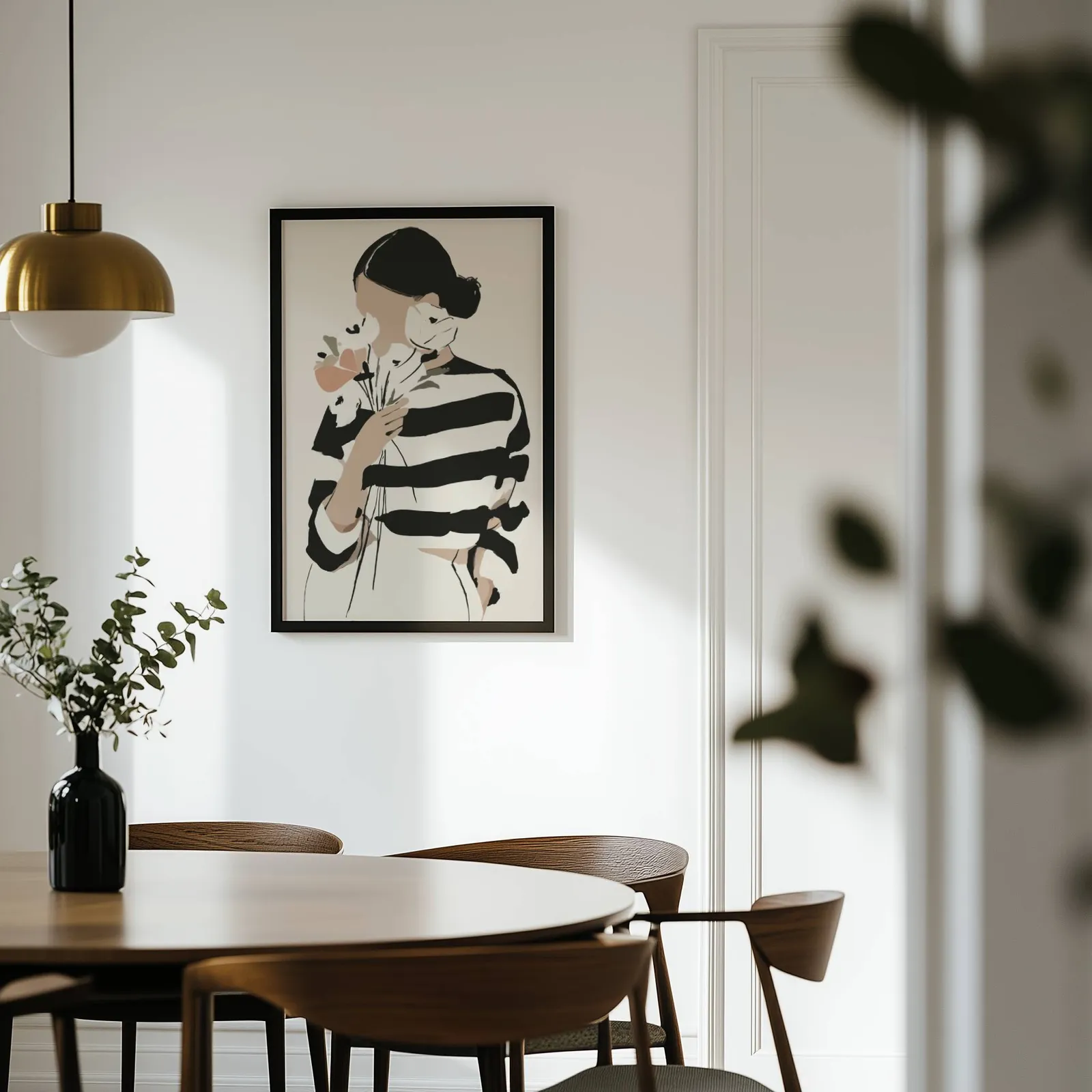 woman with flowers abstract face art print, on a white wall above a round wooden dining table