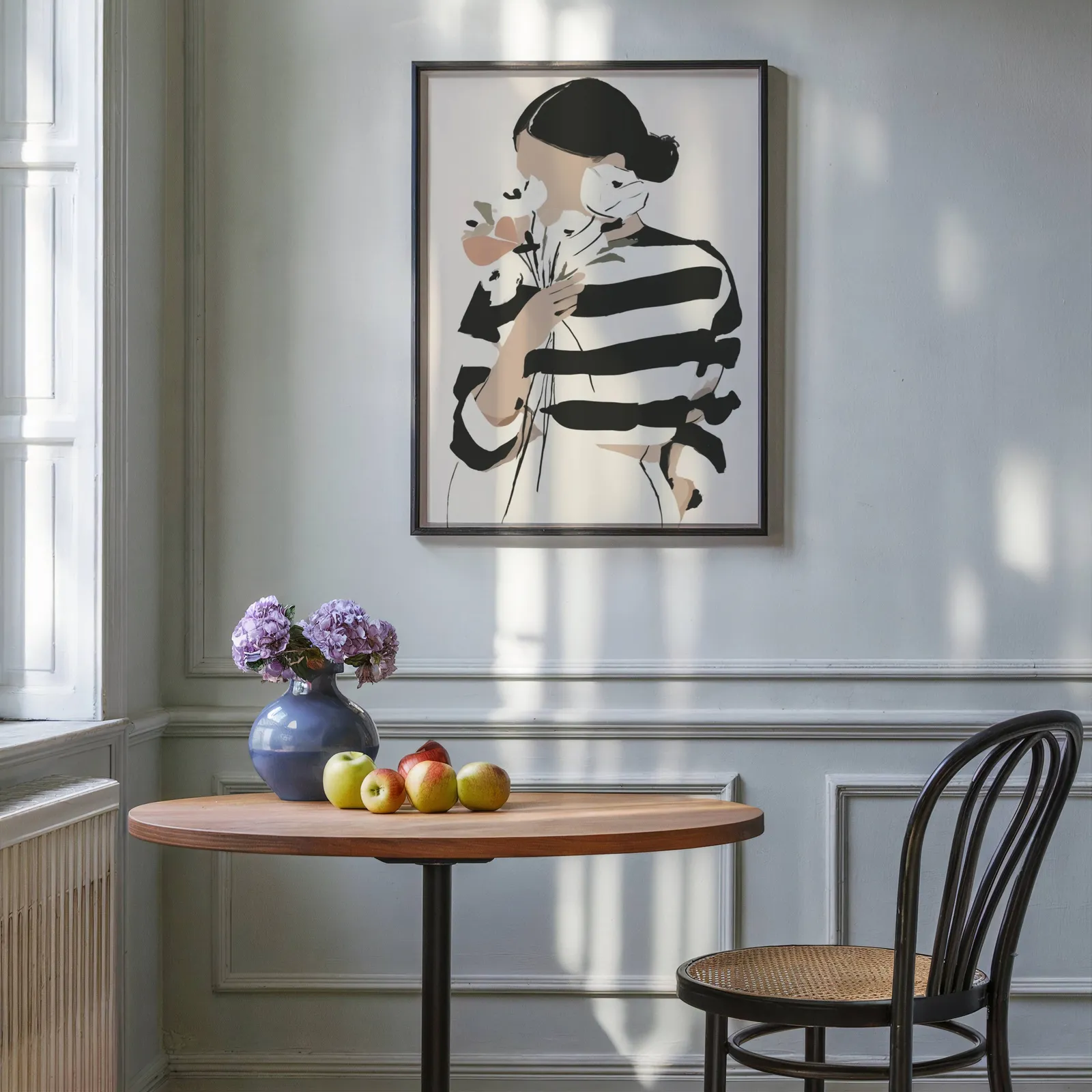 woman with flowers abstract face art print, above a round wooden table with apples and a blue vase