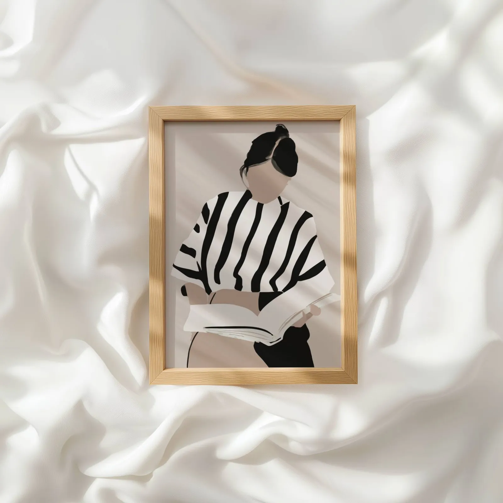 woman reading minimalist wall art, resting atop rumpled white silky fabric