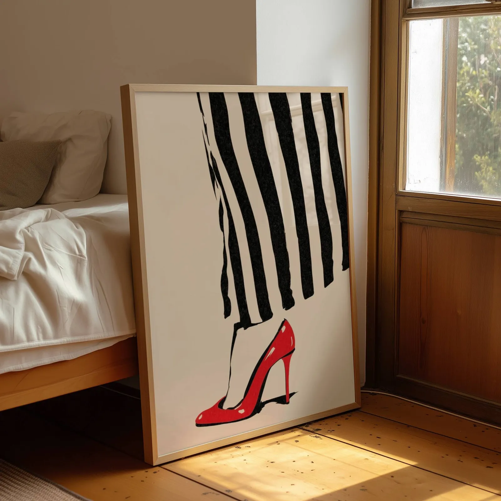 red high heel striped fashion wall art, leaning by a sunlit window beside an unmade bed