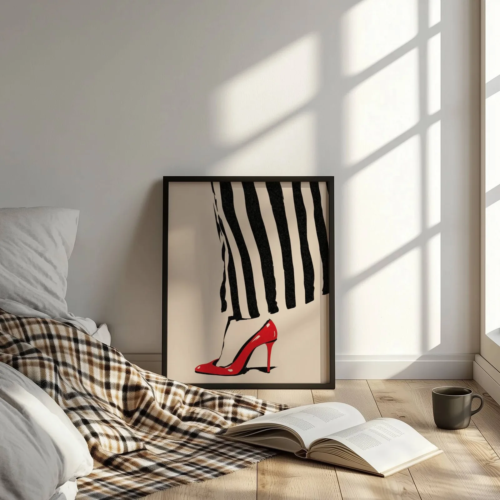 red high heel striped fashion wall art, leaning on the floor beside a plaid throw and open book