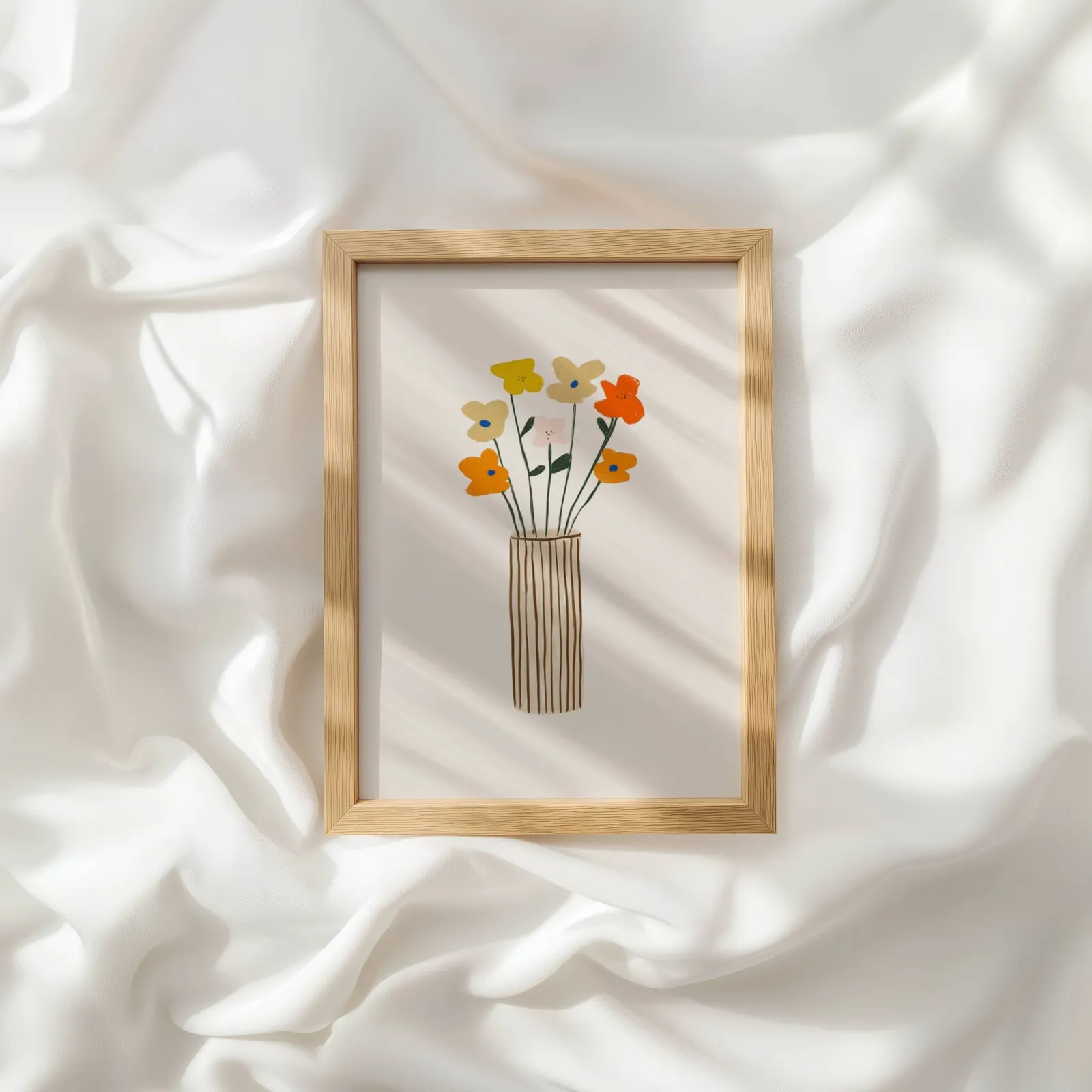 colorful floral wall art with striped vase, resting atop rumpled white silky fabric