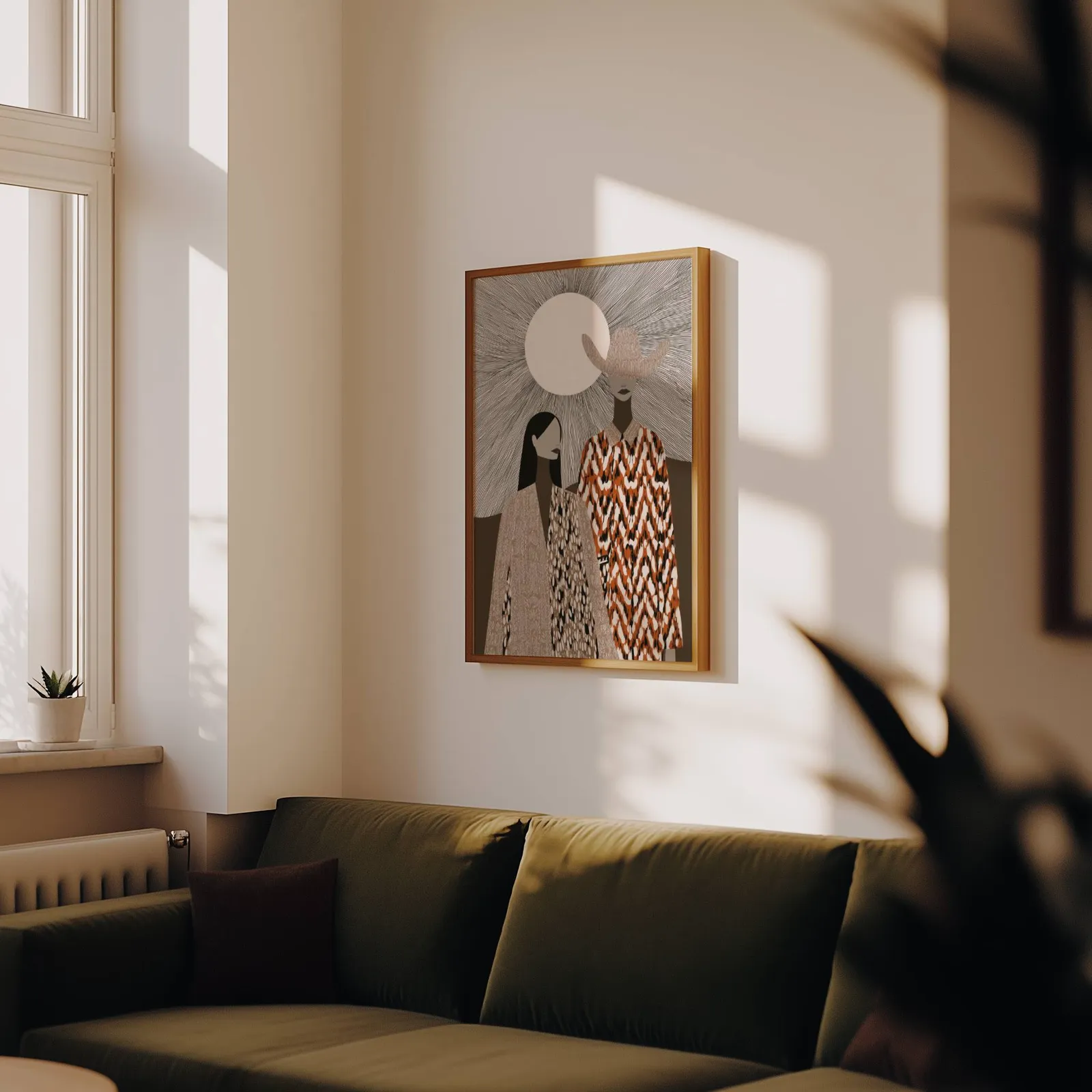 boho western wall art with two women in patterned cloaks, above an olive velvet sofa in raking afternoon light