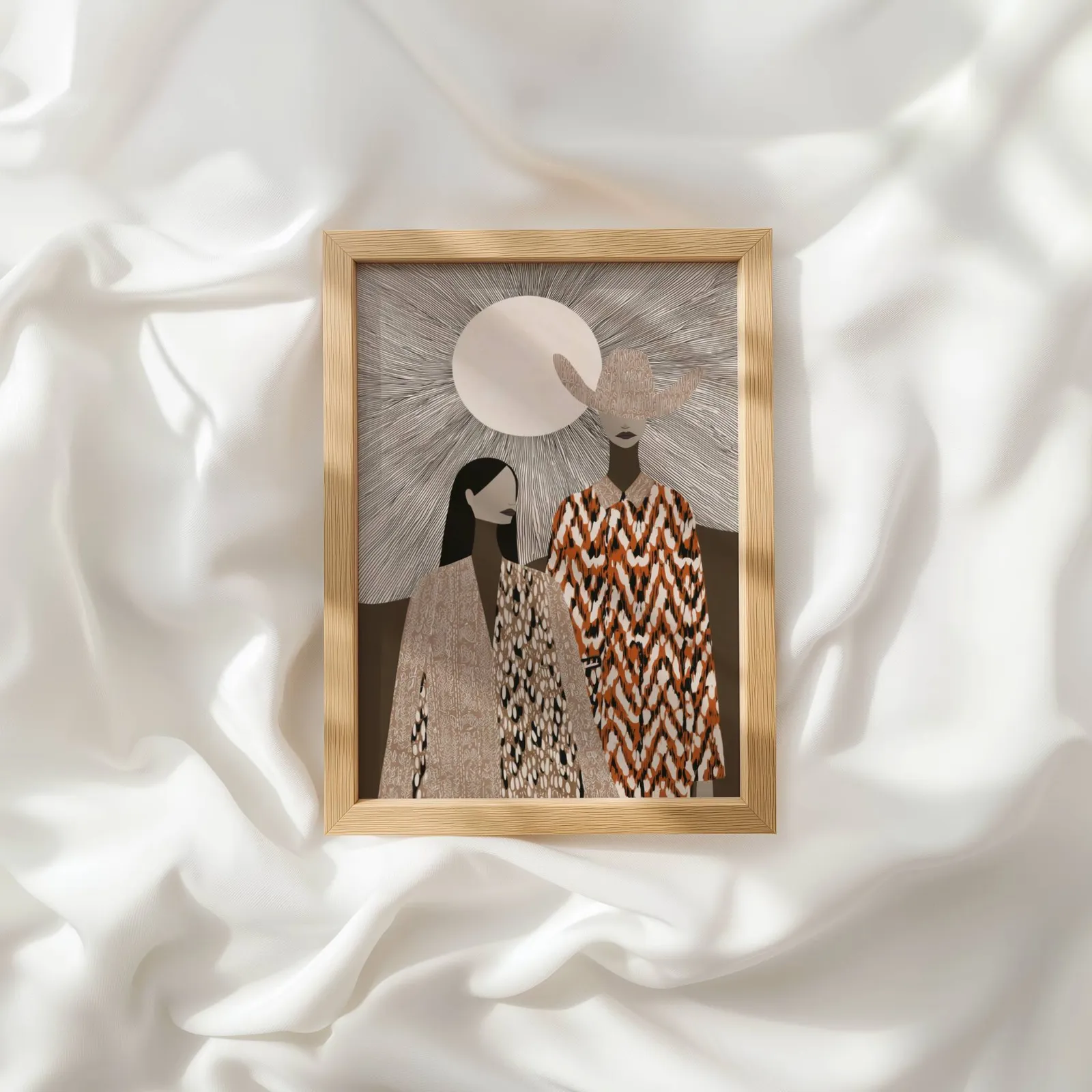 boho western wall art with two women in patterned cloaks, resting atop rumpled white silky fabric