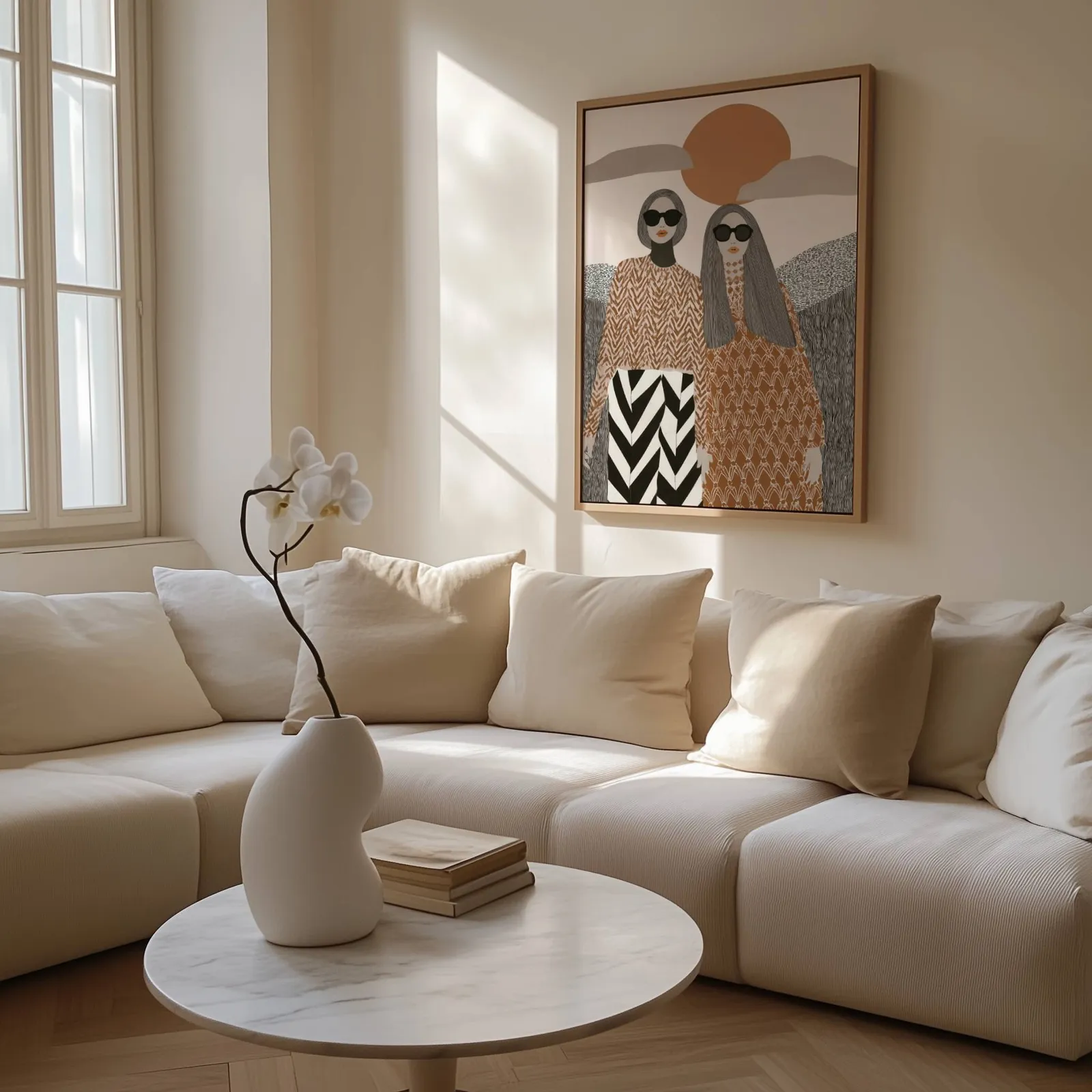 terracotta boho portrait wall art of two women, above a cream sectional beside a tall sunlit window