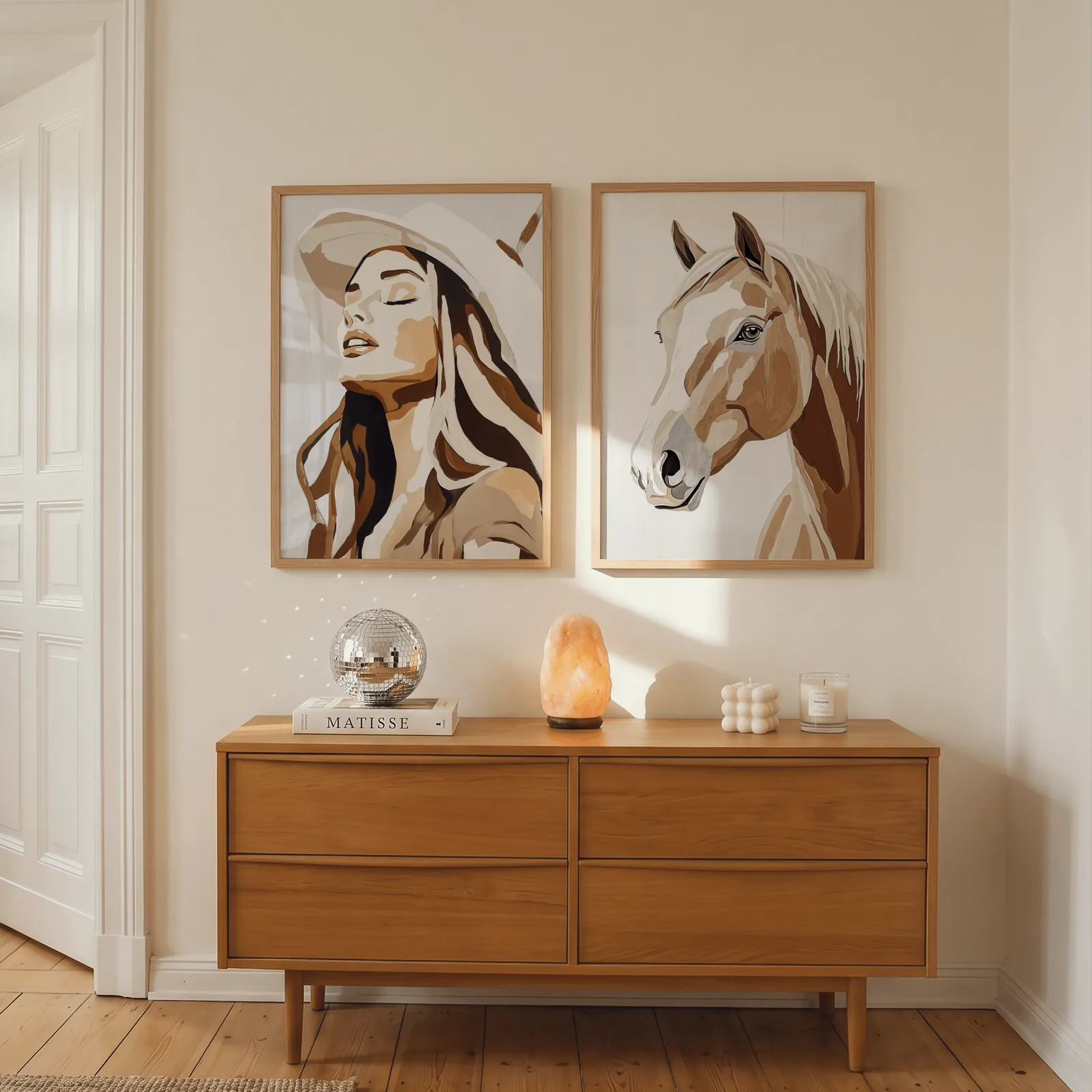 western cowgirl and horse wall art set in brown and beige, above a wooden dresser with a salt lamp and disco ball