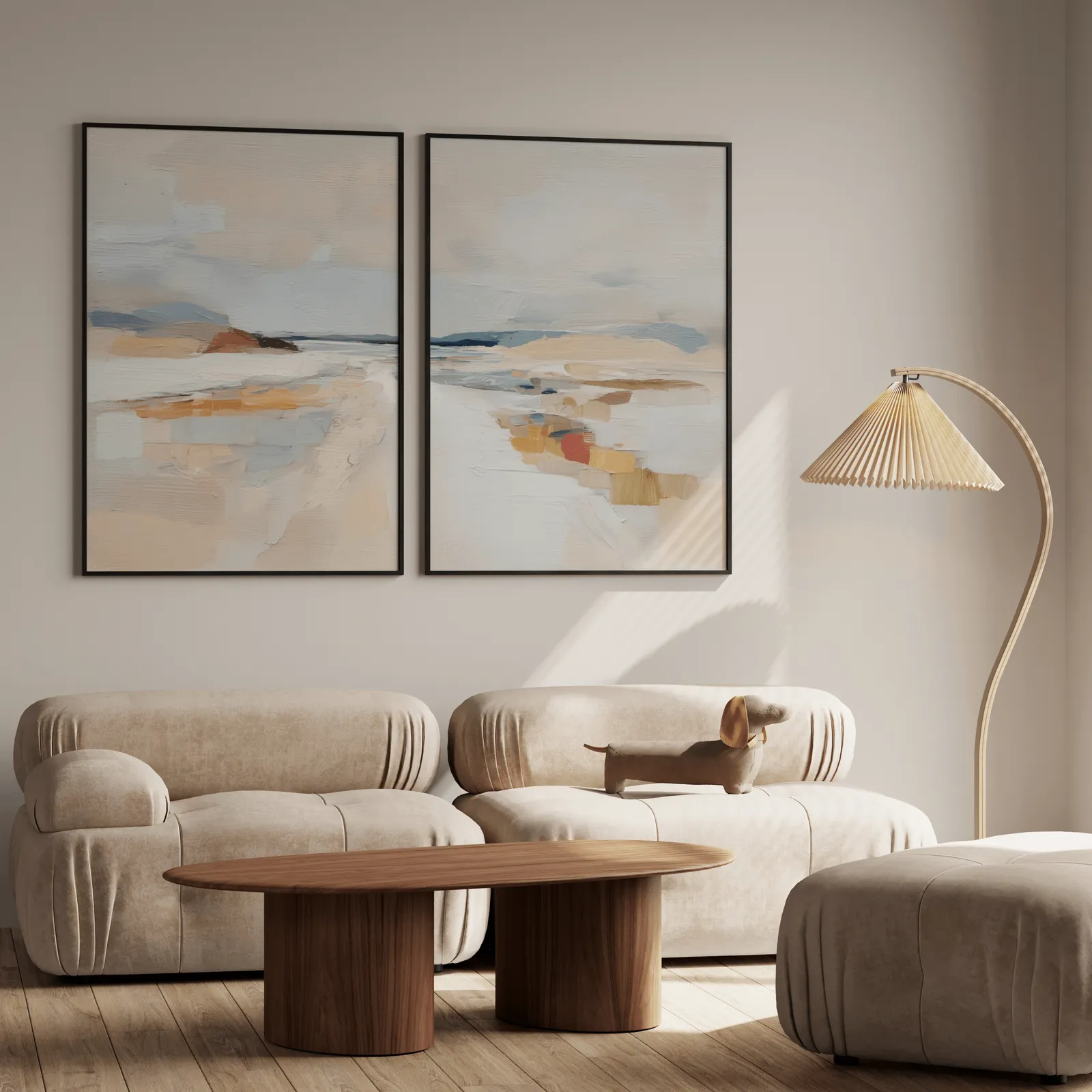 beige coastal abstract wall art set of two, above a plush beige sofa with a pleated lamp nearby