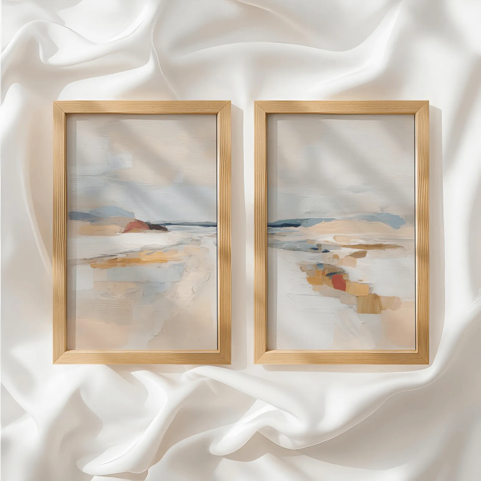 beige coastal abstract wall art set of two, side by side atop rumpled white silky fabric