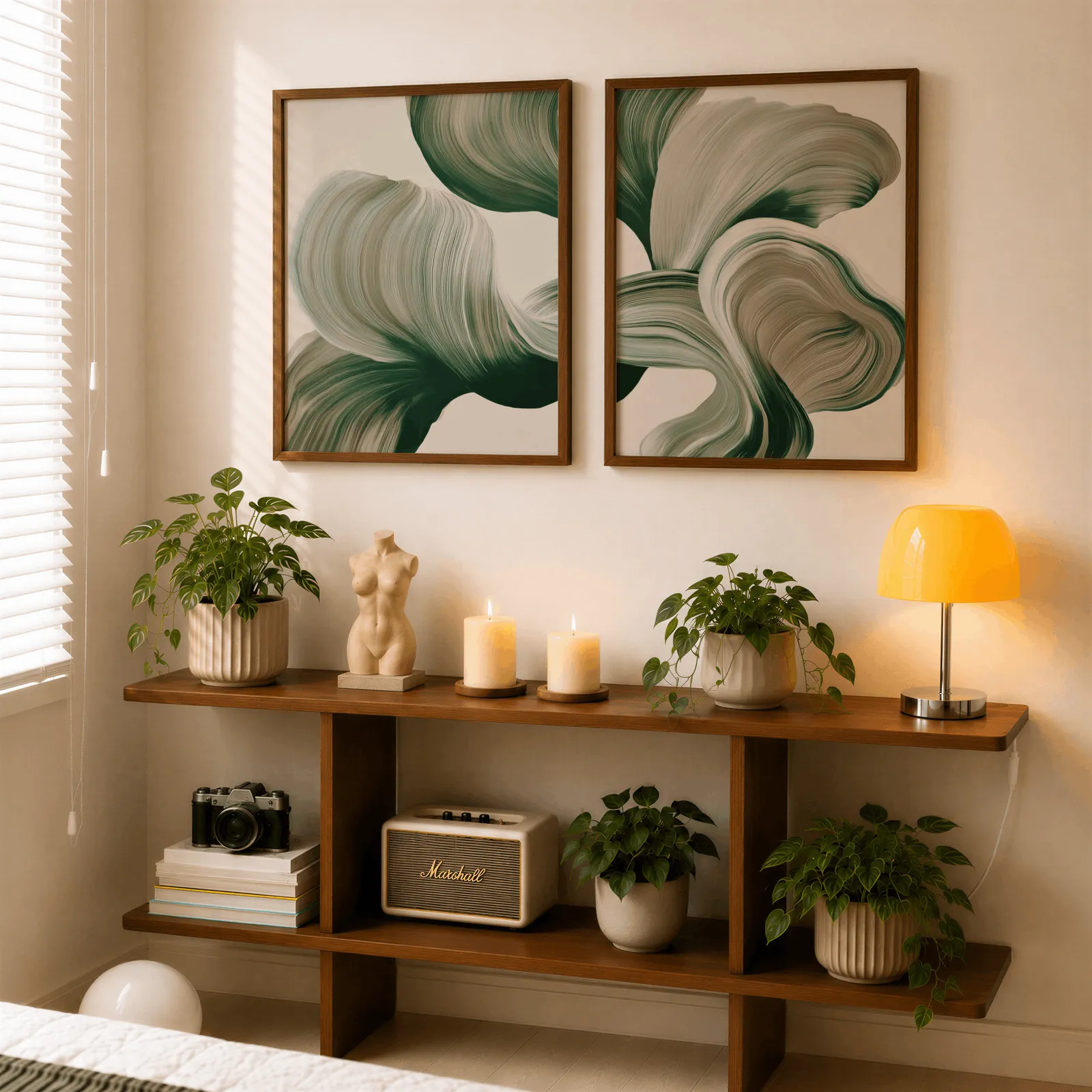 green abstract botanical wall art set of two, above a wooden console shelf with potted plants and a yellow lamp