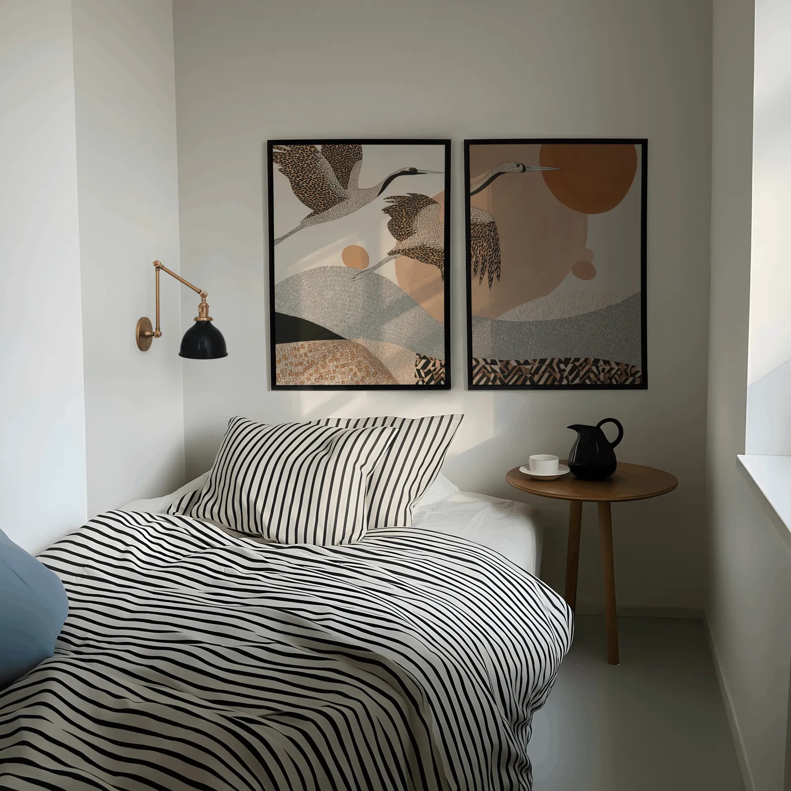 terracotta crane wall art set of two abstract landscape prints, above a striped bed beside a brass swing-arm lamp