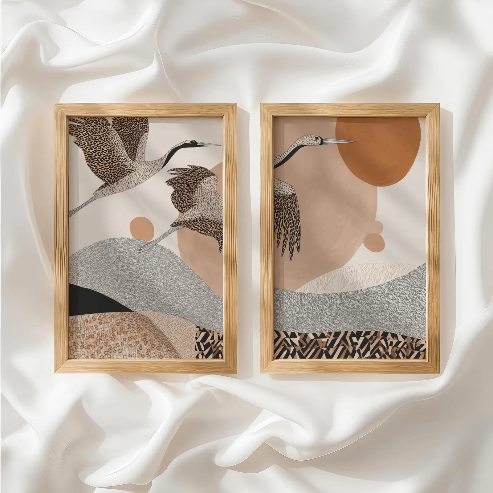 terracotta crane wall art set of two abstract landscape prints, side by side atop rumpled white silky fabric
