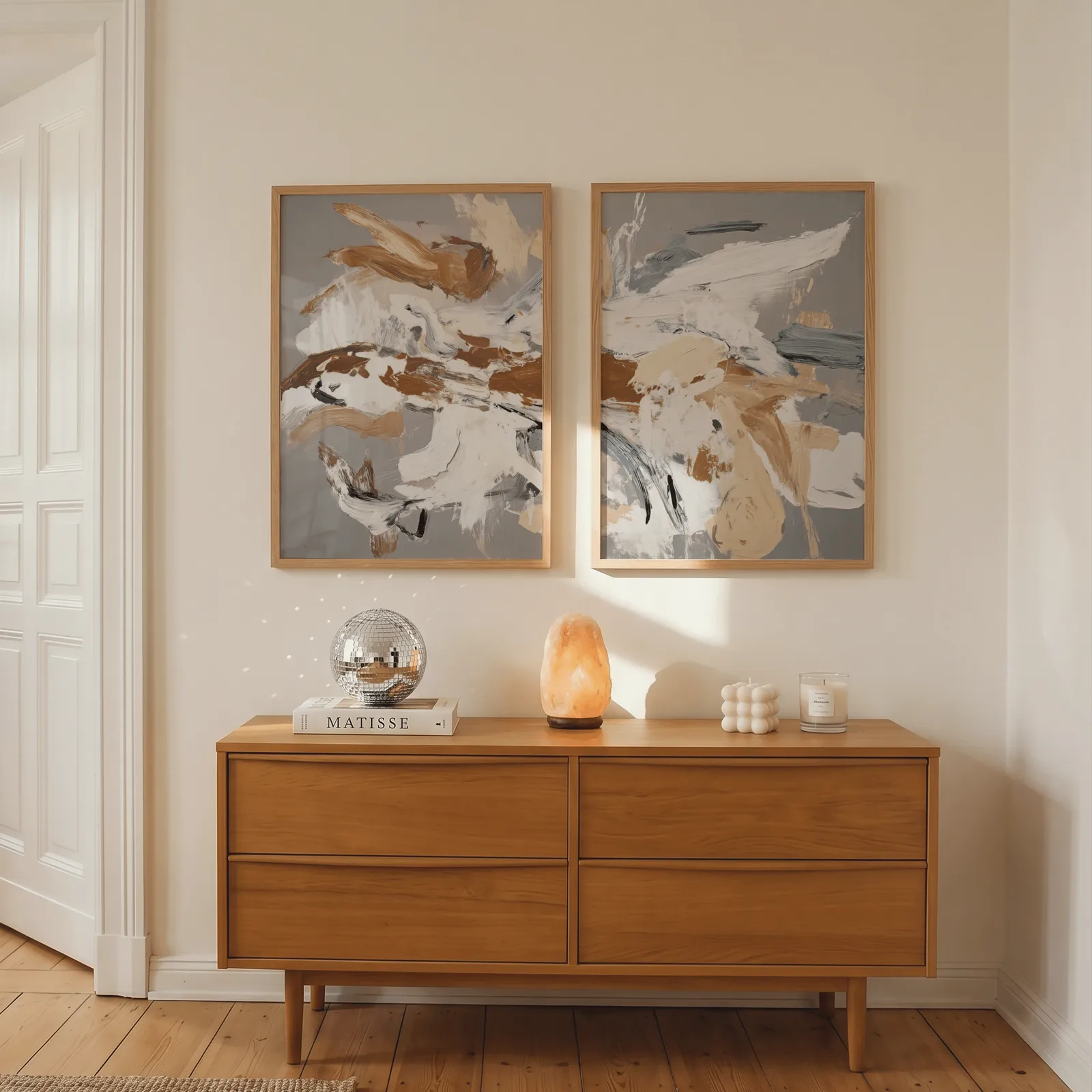 terracotta abstract wall art set of two, above a wooden dresser with a salt lamp and disco ball