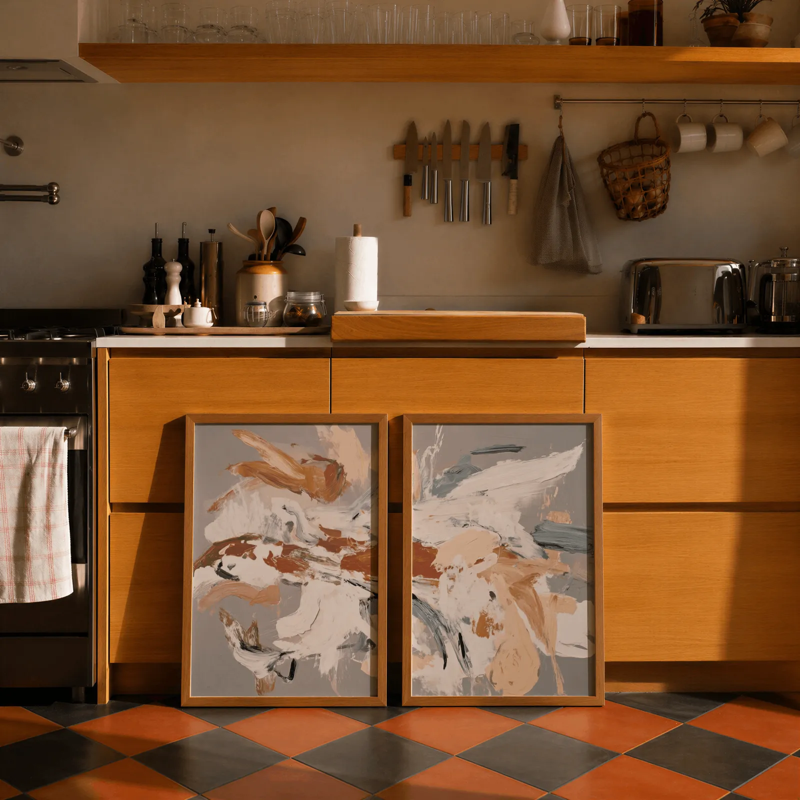 terracotta abstract wall art set of two, leaning against wooden cabinets on terracotta tiled floor