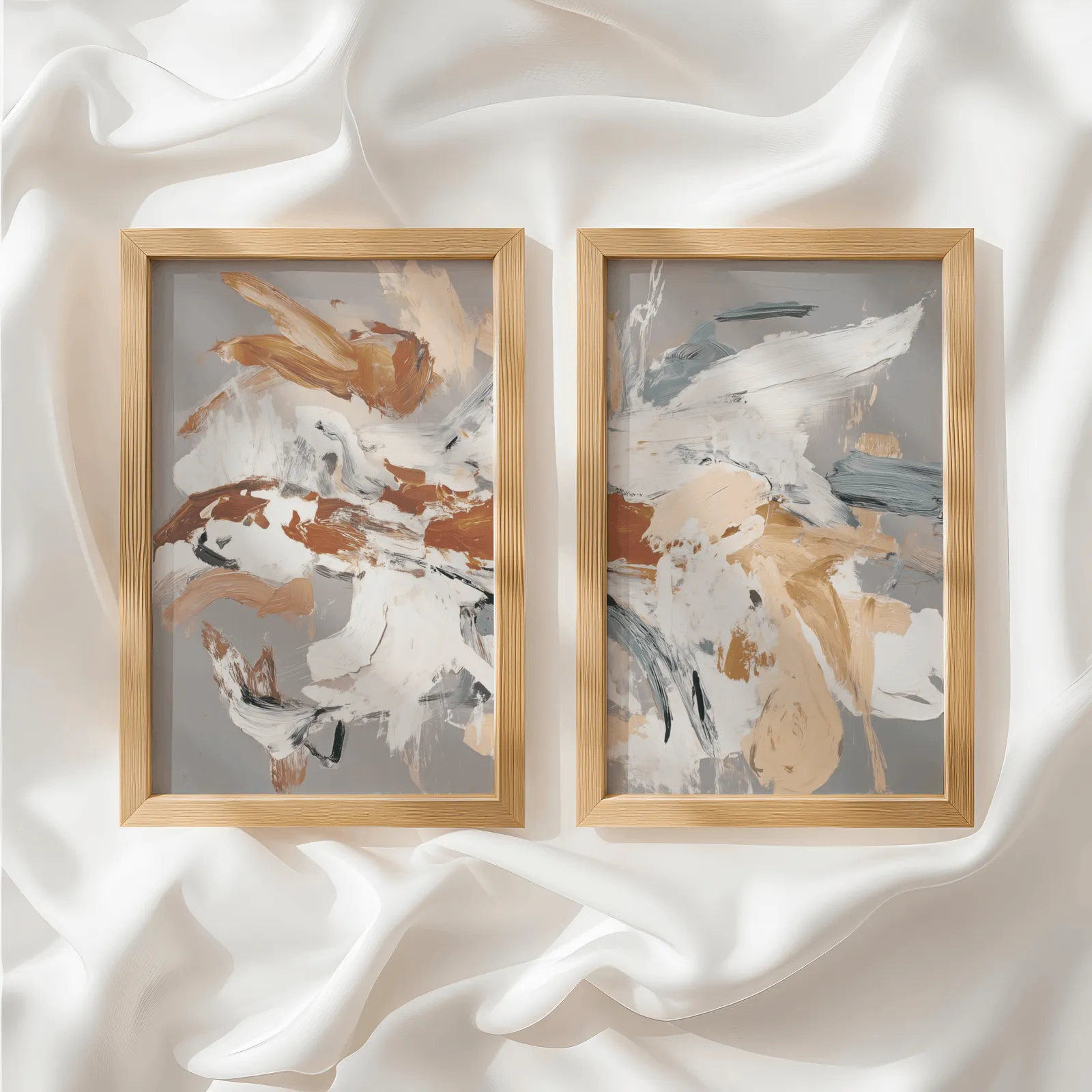 terracotta abstract wall art set of two, side by side atop rumpled white silky fabric