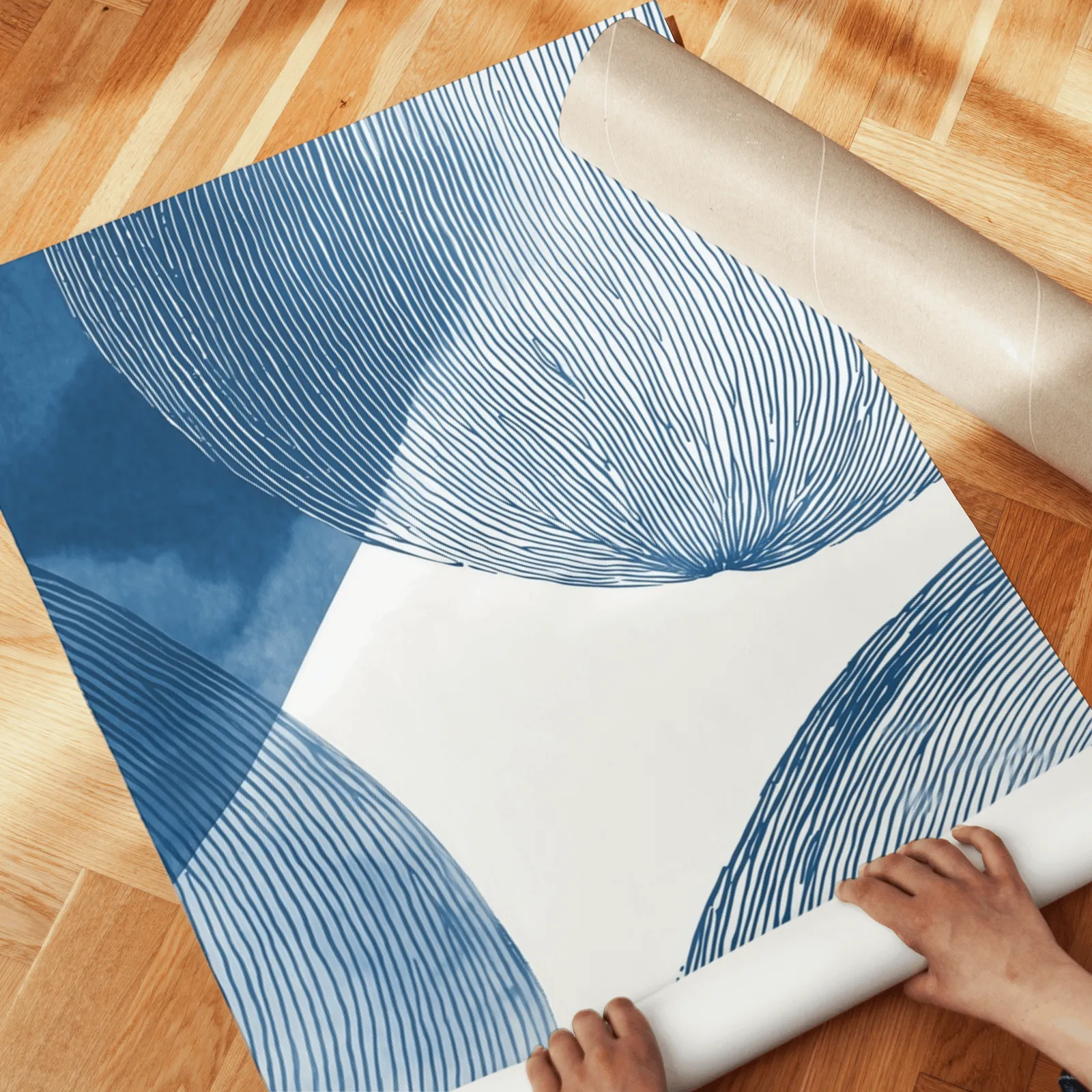 blue abstract circular line triptych wall art, unrolled across a herringbone wood floor by hand