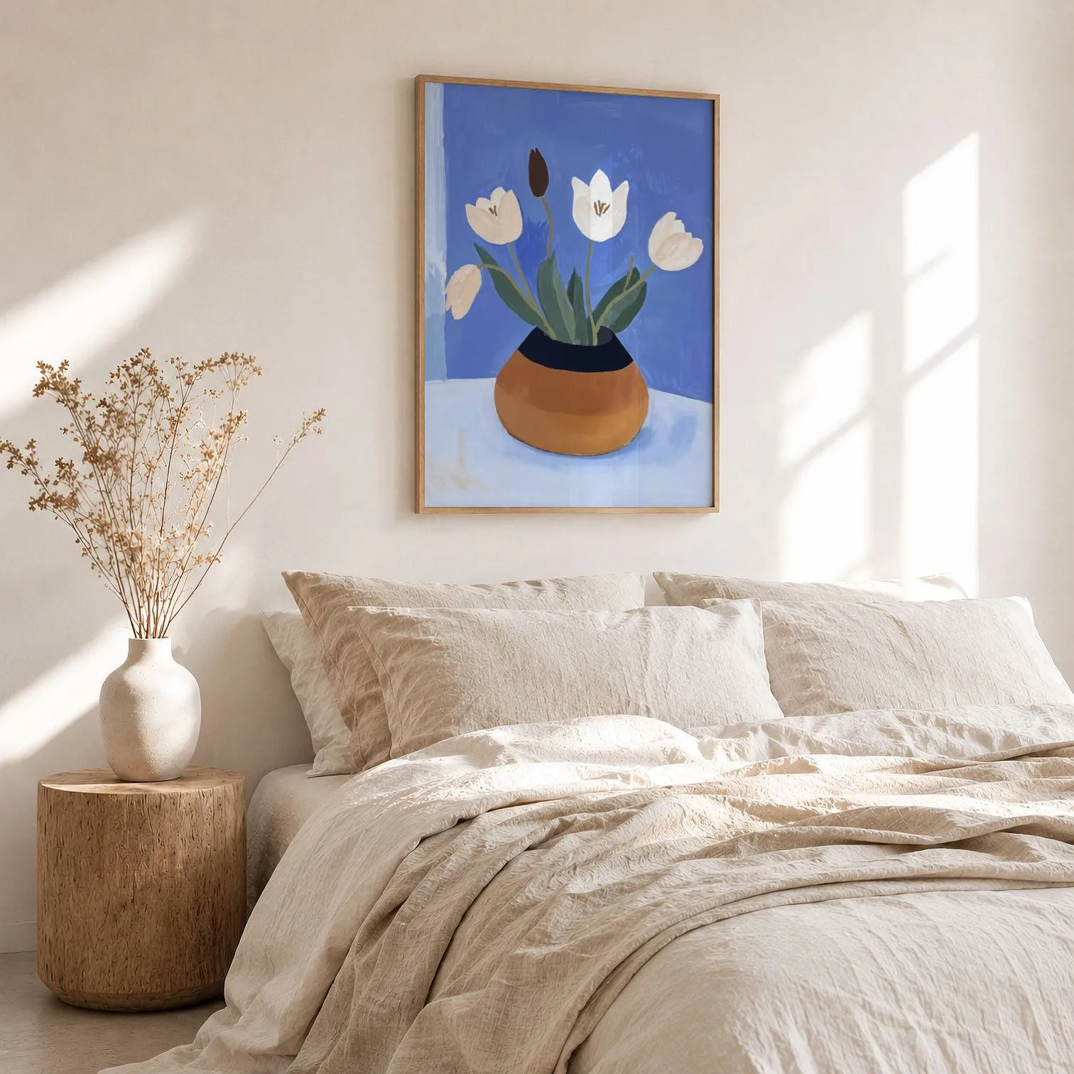 white tulips in terracotta vase botanical wall art, above a rumpled linen bed beside a stump side table