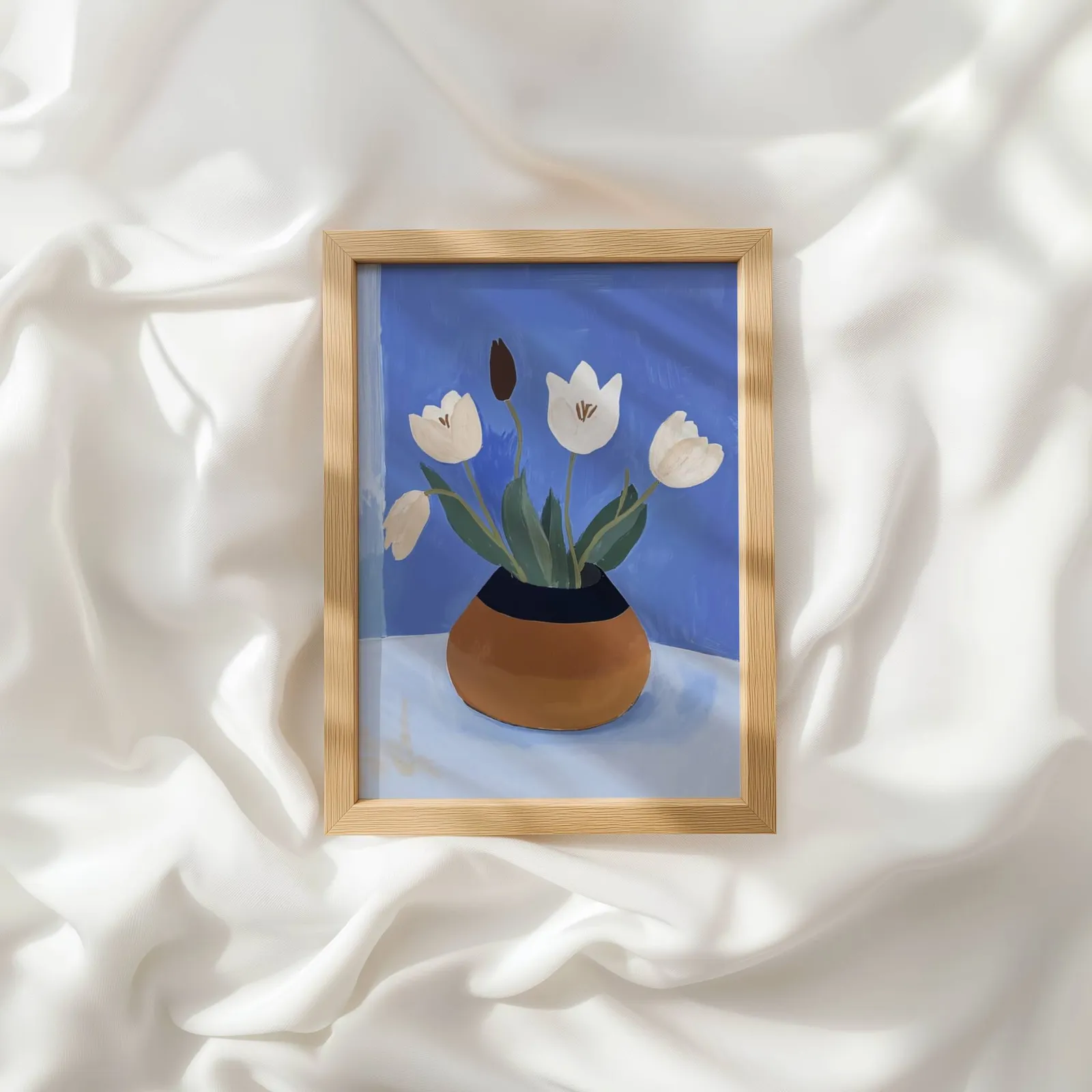 white tulips in terracotta vase botanical wall art, resting atop rumpled white silky fabric