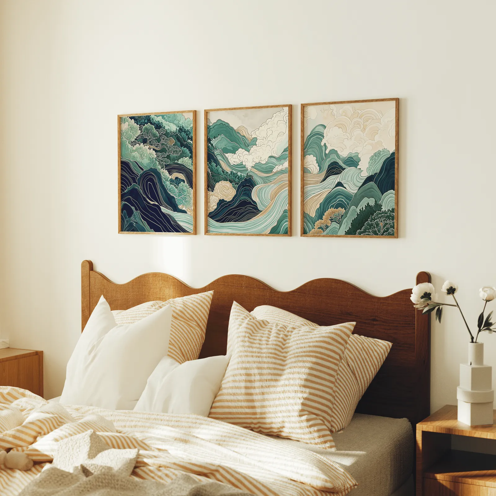 green mountain landscape wall art set of three, above a scalloped wooden headboard with striped pillows