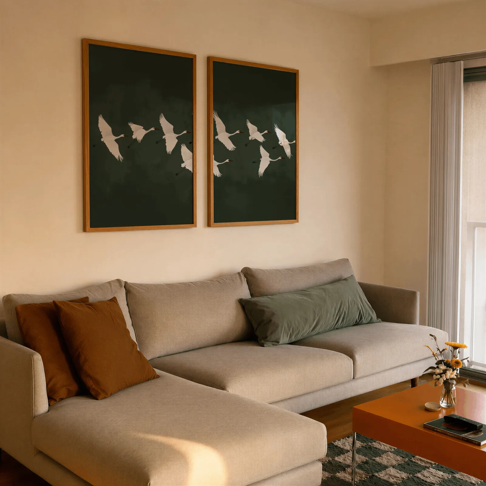 green crane wall art set of two, side by side above a beige sectional sofa