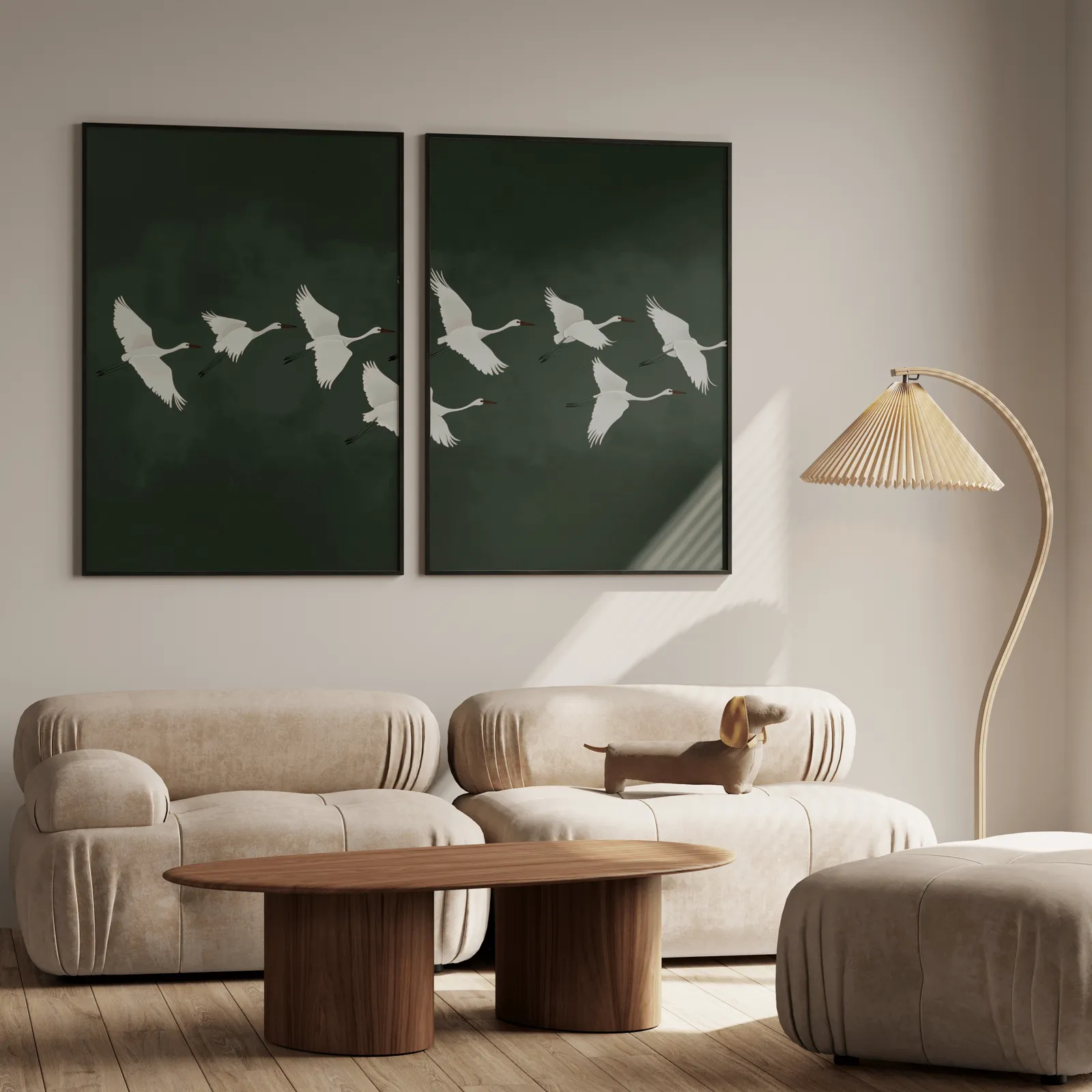 green crane wall art set of two, above a plush beige sofa with a pleated lamp nearby