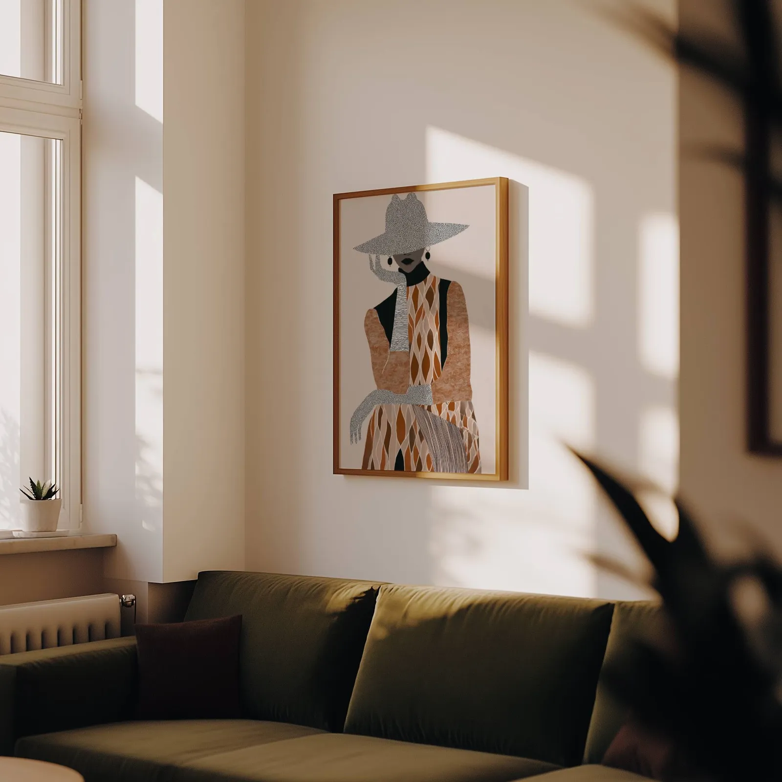 boho woman portrait wall art in brown and cream, above an olive velvet sofa in raking afternoon light