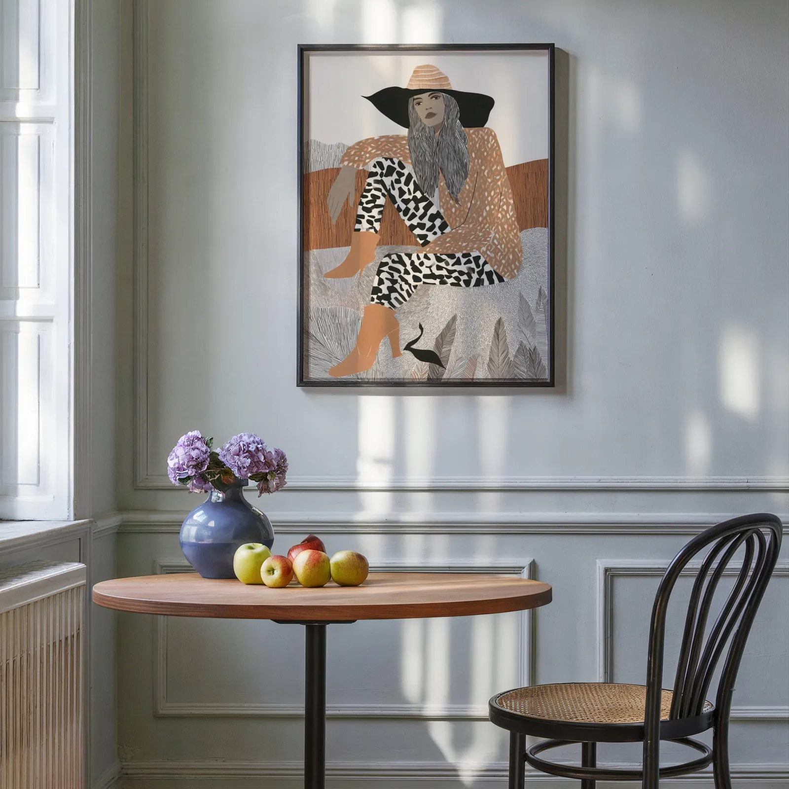 terracotta boho woman portrait wall art, above a round wooden table with apples and a blue vase