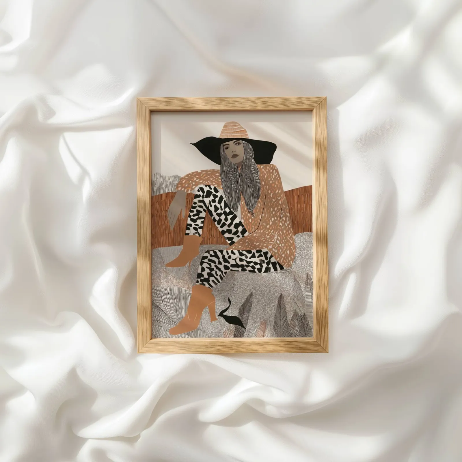 terracotta boho woman portrait wall art, resting atop rumpled white silky fabric