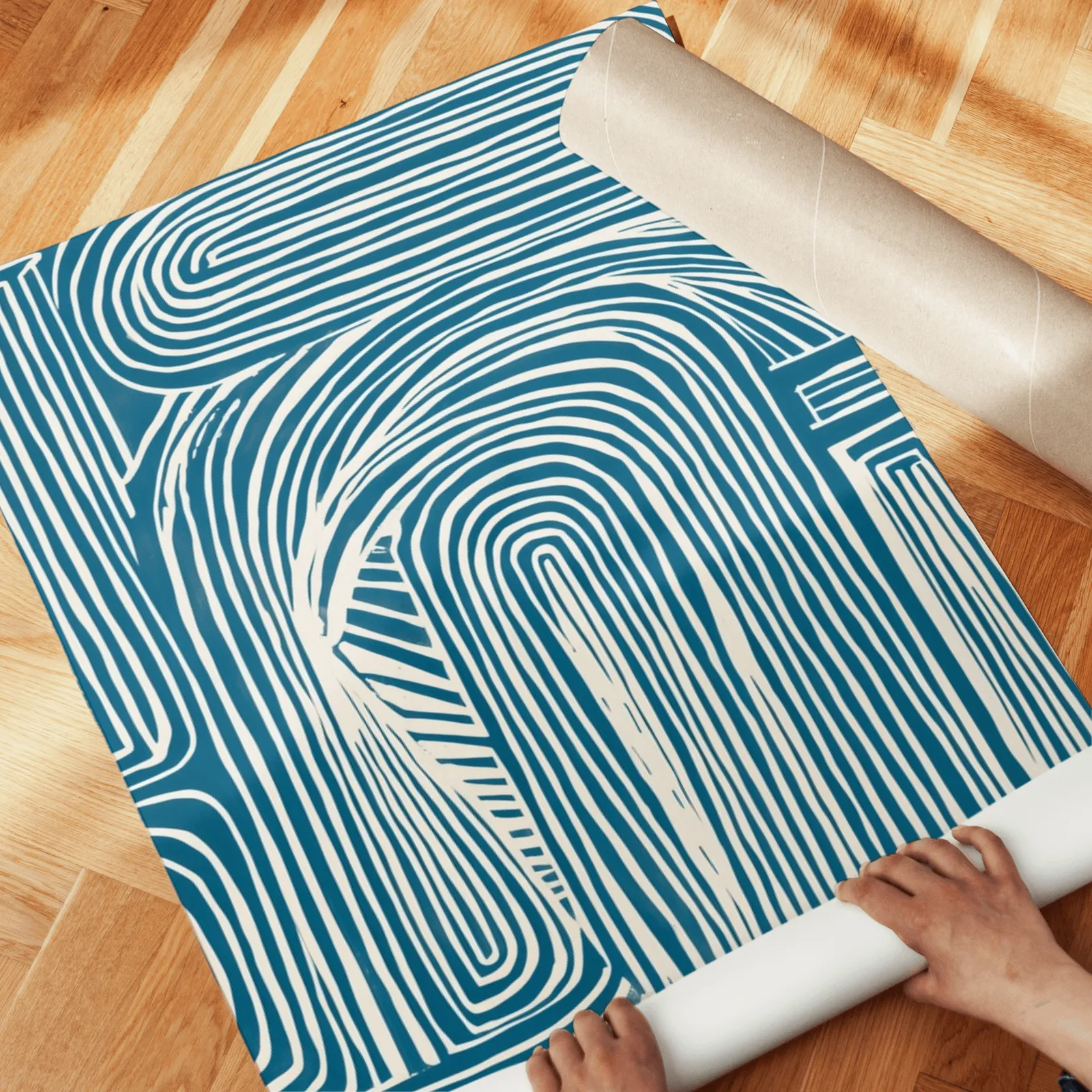 blue abstract line pattern wall art set of 2, unrolled across a herringbone parquet floor by hand