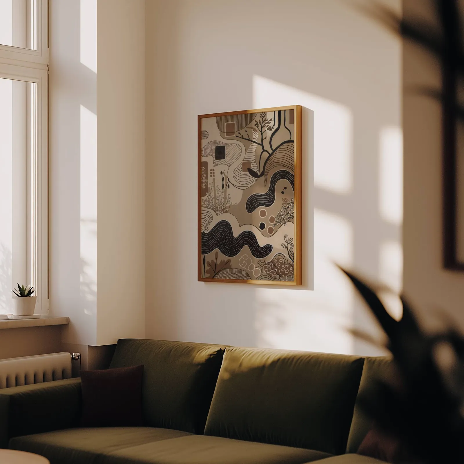 brown abstract nature wall art with winding lines, above an olive velvet sofa in raking afternoon light