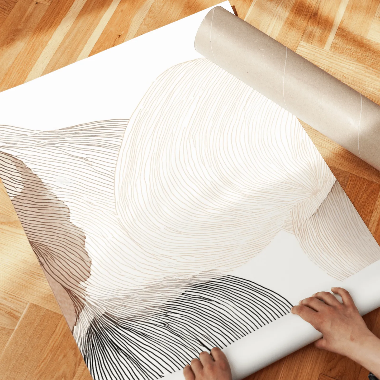 abstract three piece wall art in brown and grey, unrolled across a herringbone wood floor by hand