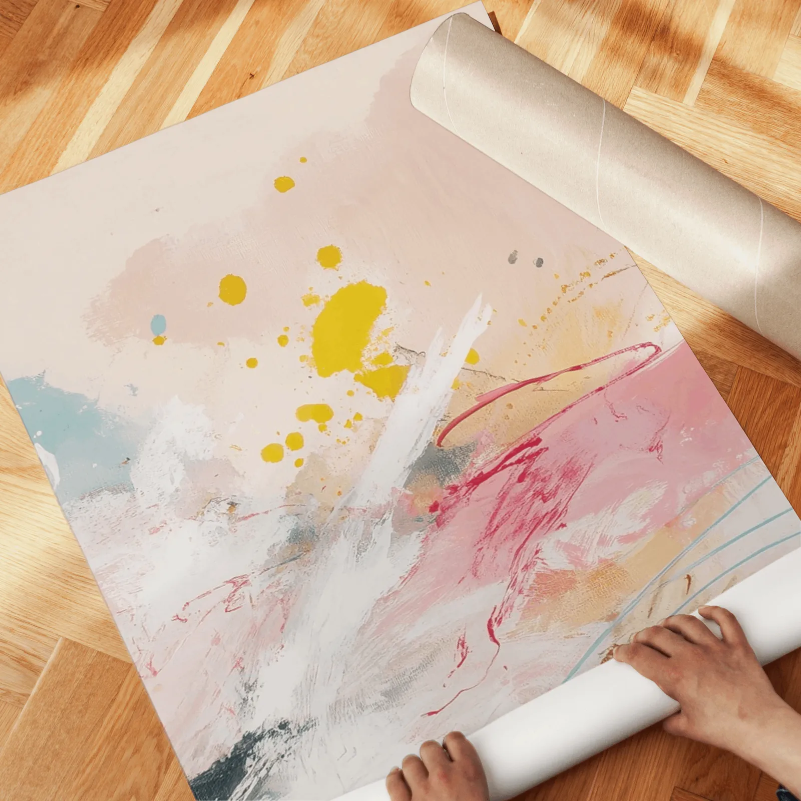 colorful abstract triptych wall art in yellow and pink, unrolled across a herringbone wood floor by hand