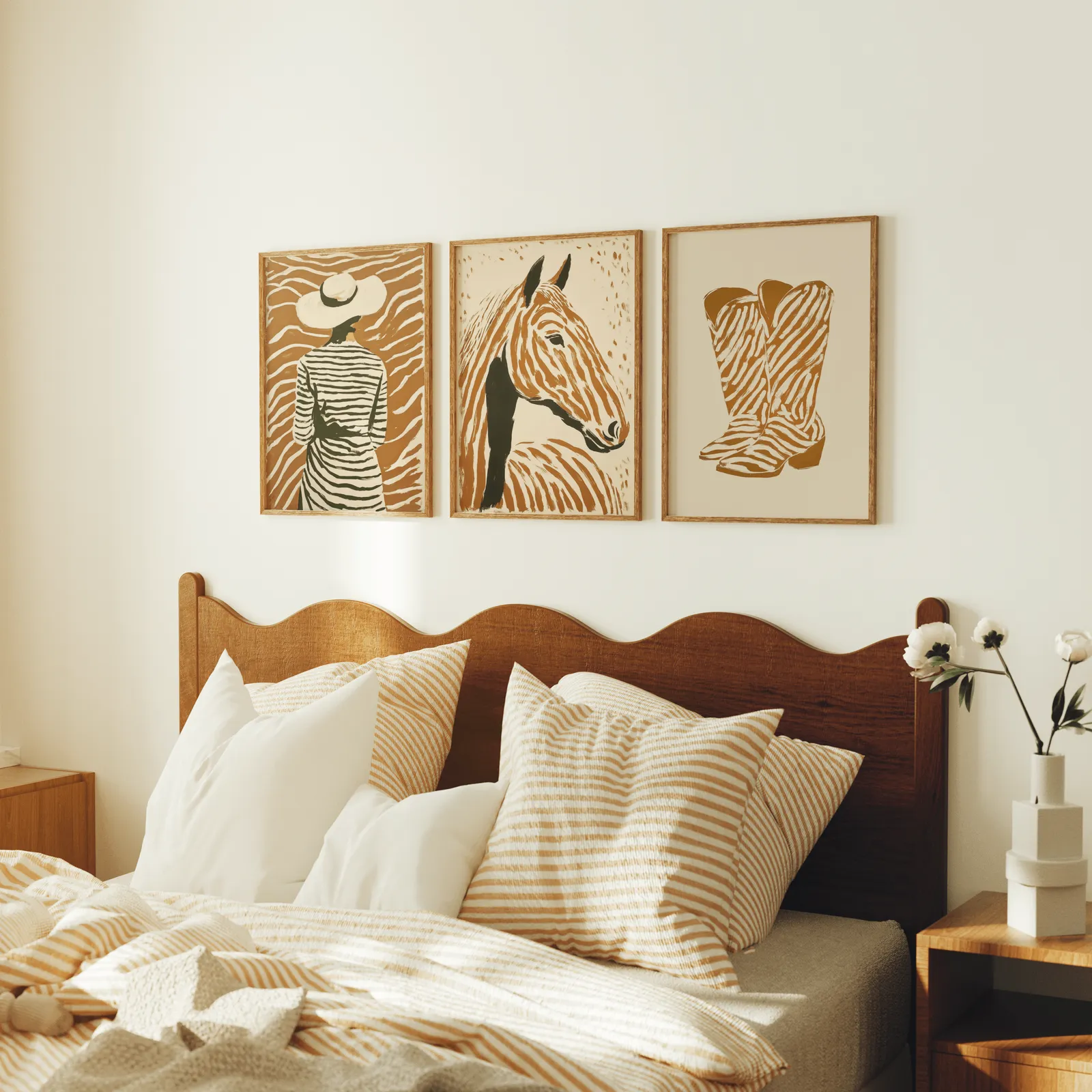 terracotta western set of 3 wall art with woman horse and boots, above a scalloped wooden headboard with striped pillows